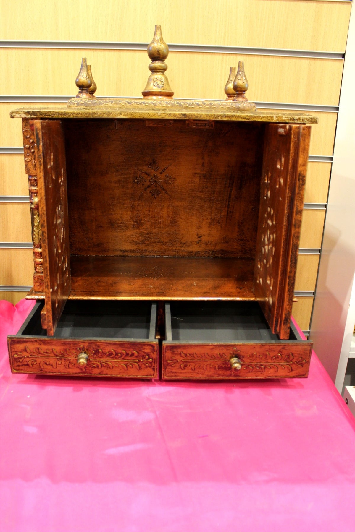 Antique wooden mandir with base drawers open for puja essentials