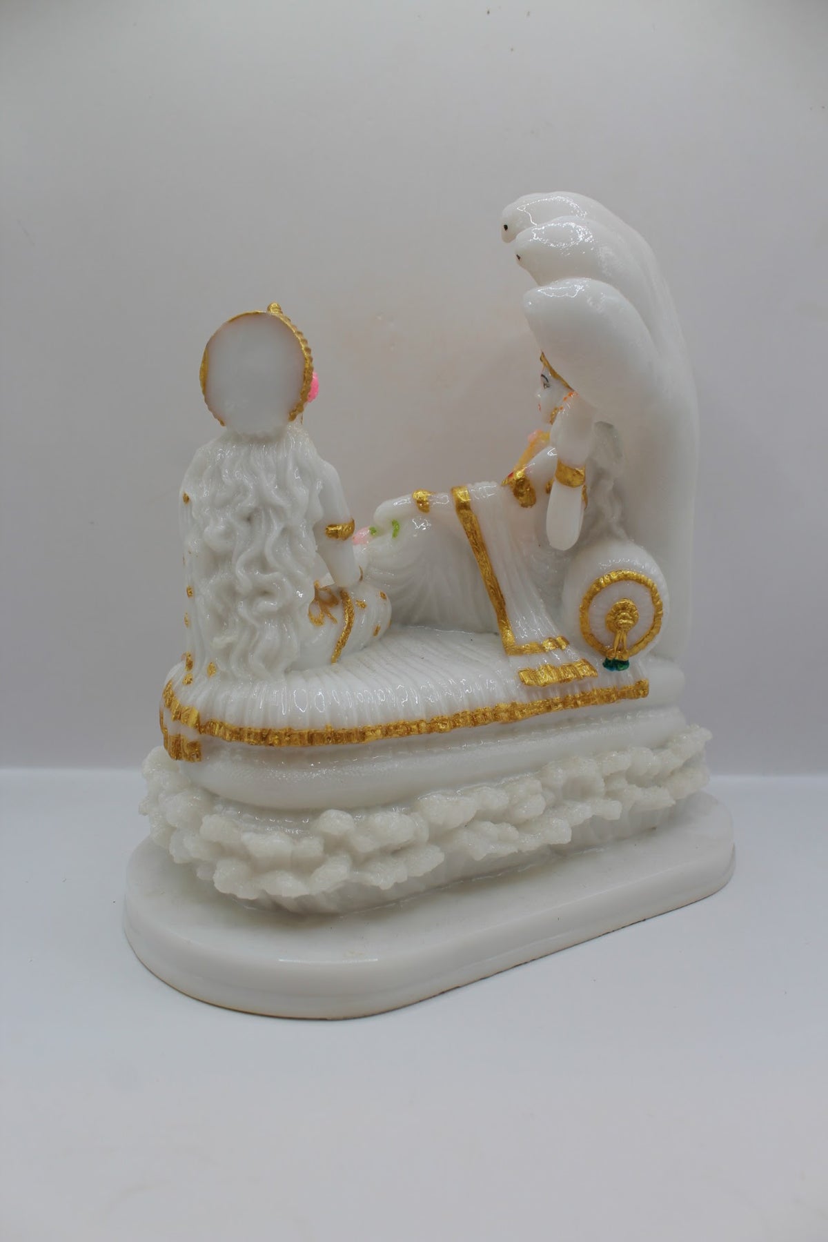 White and gold resin Vishnu Laxmi murti on Sheshnaag, back view