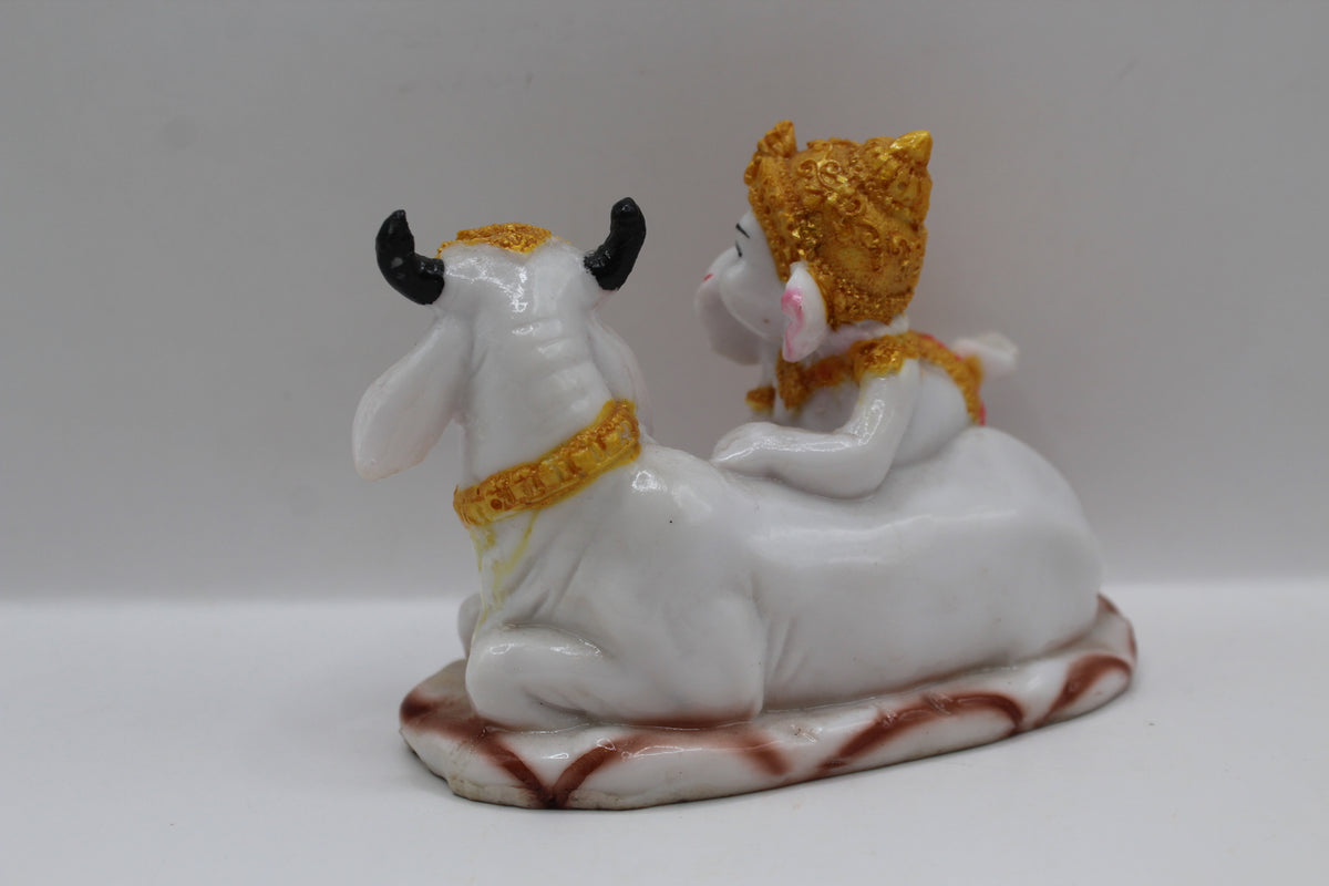 Baby Ganesh murti with white cow, back view