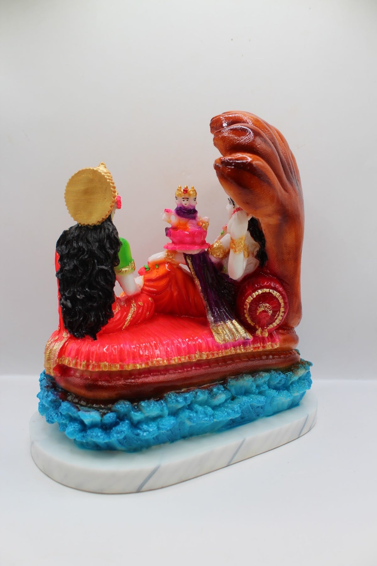 Colourful resin Vishnu Laxmi murti on Sheshnaag, back view