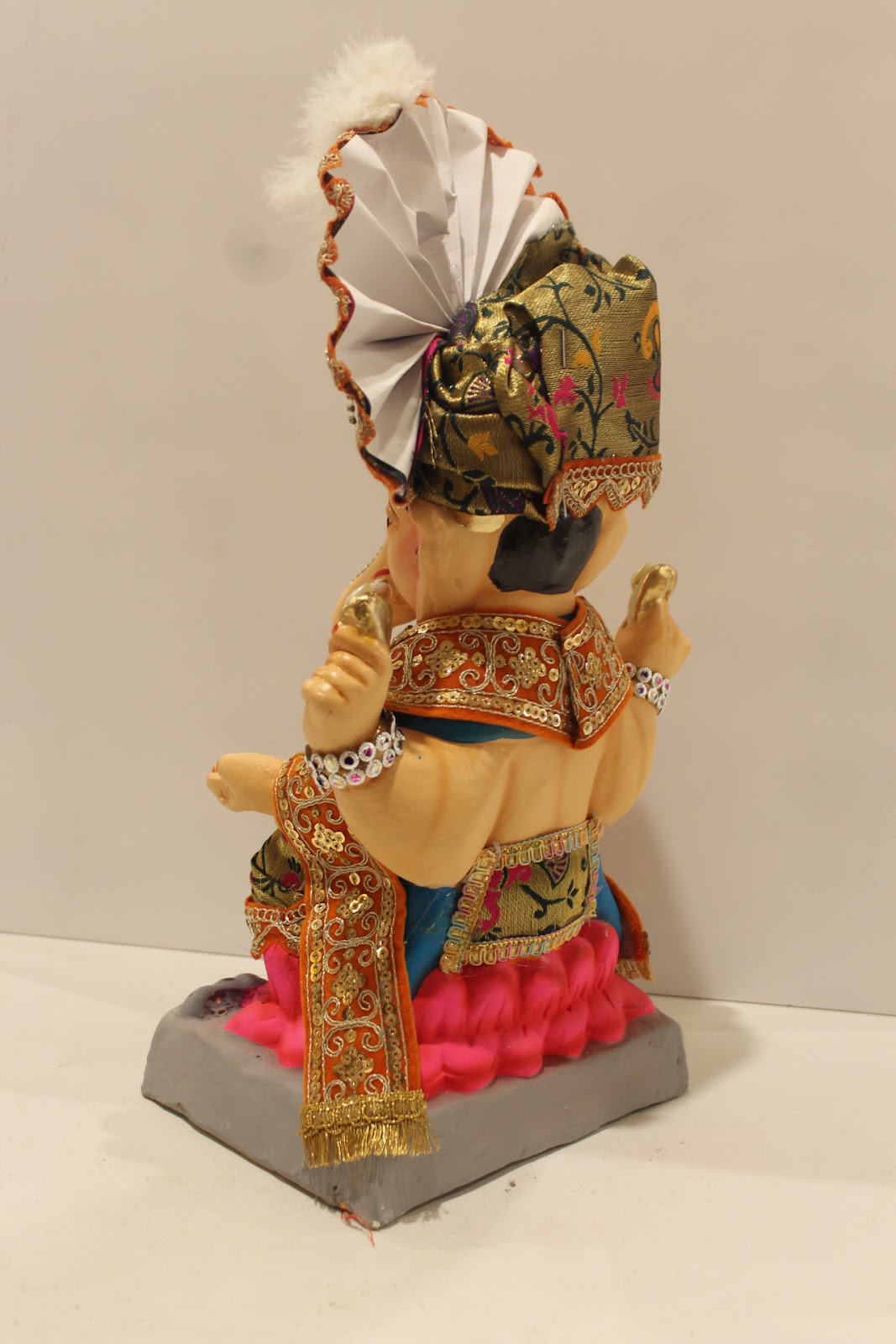 Eco-friendly clay Ganesh idol with green brocade safa and pink dhoti, back view