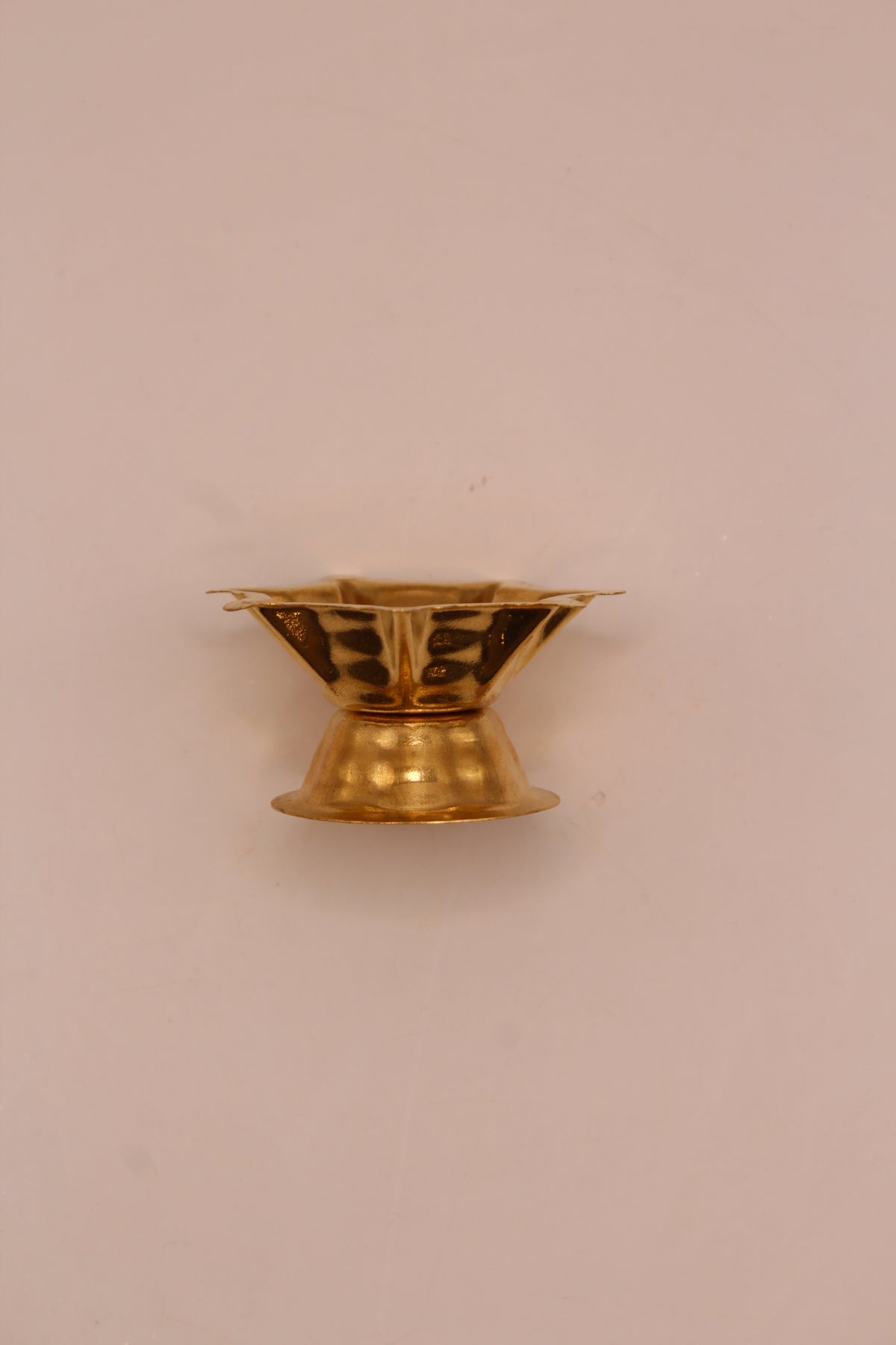 Small gold metal diya, low view