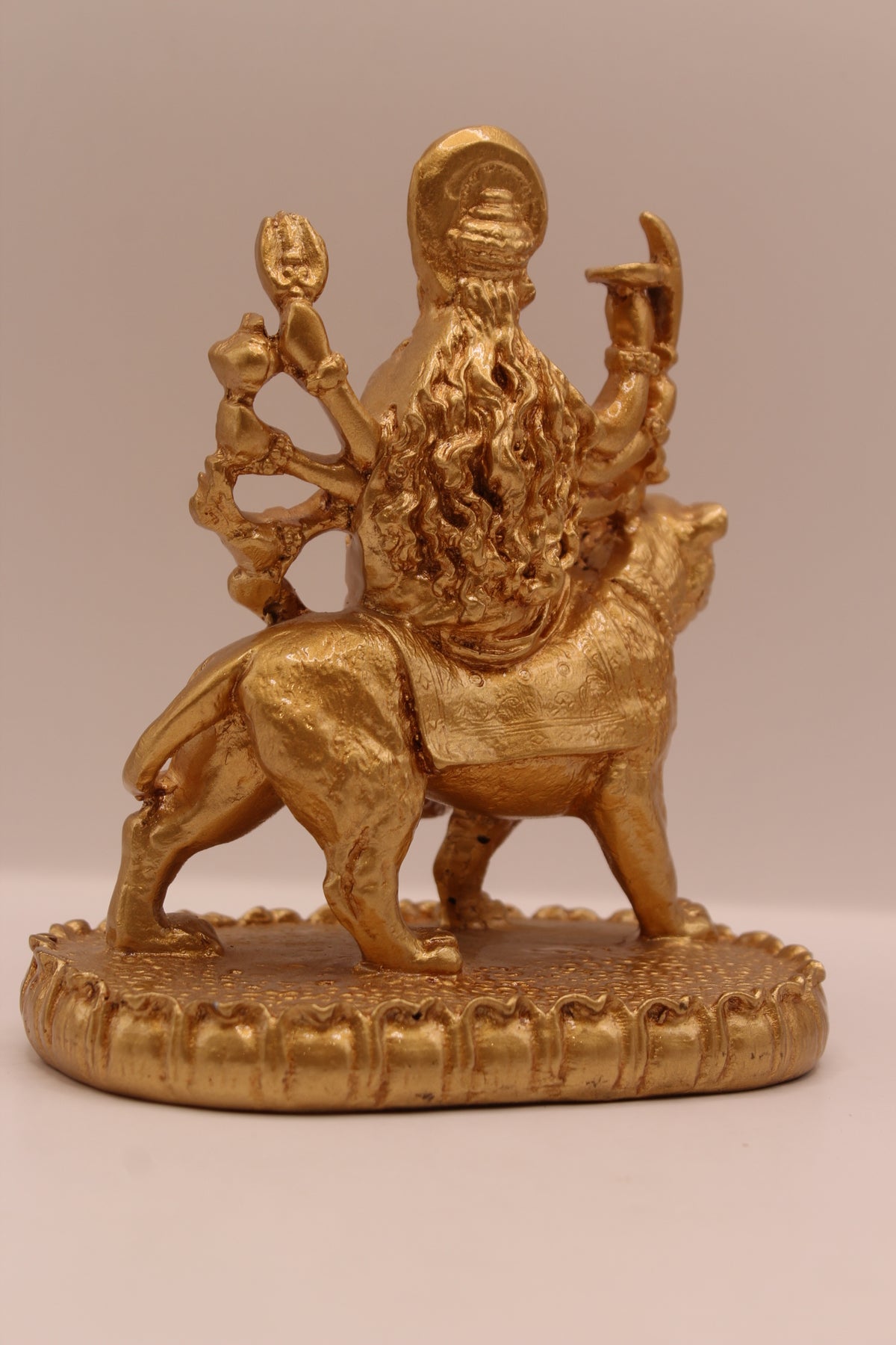 Gold Ambe Maa on lion statue, back