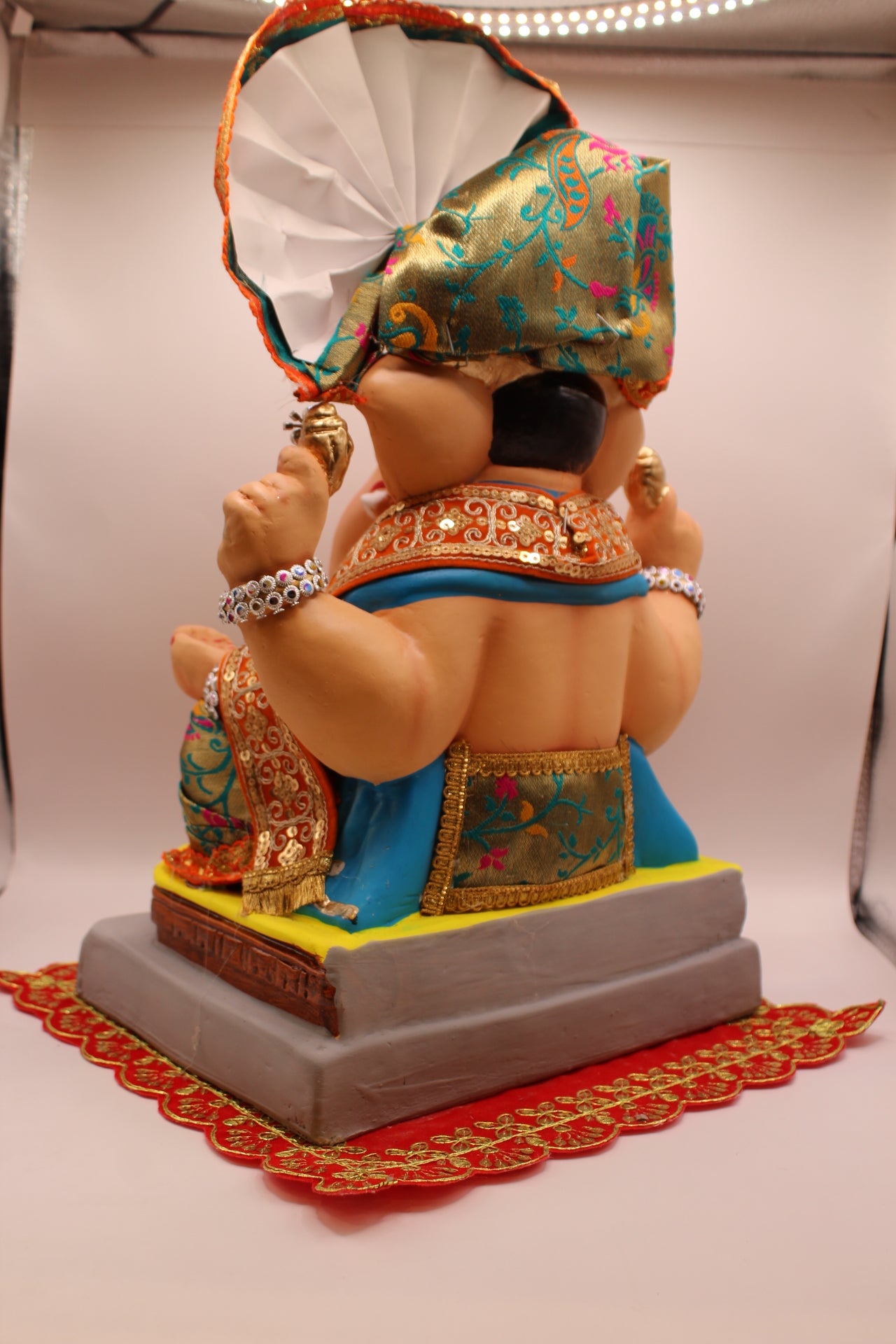Back view – teal floral safa with orange gold brocade outfit