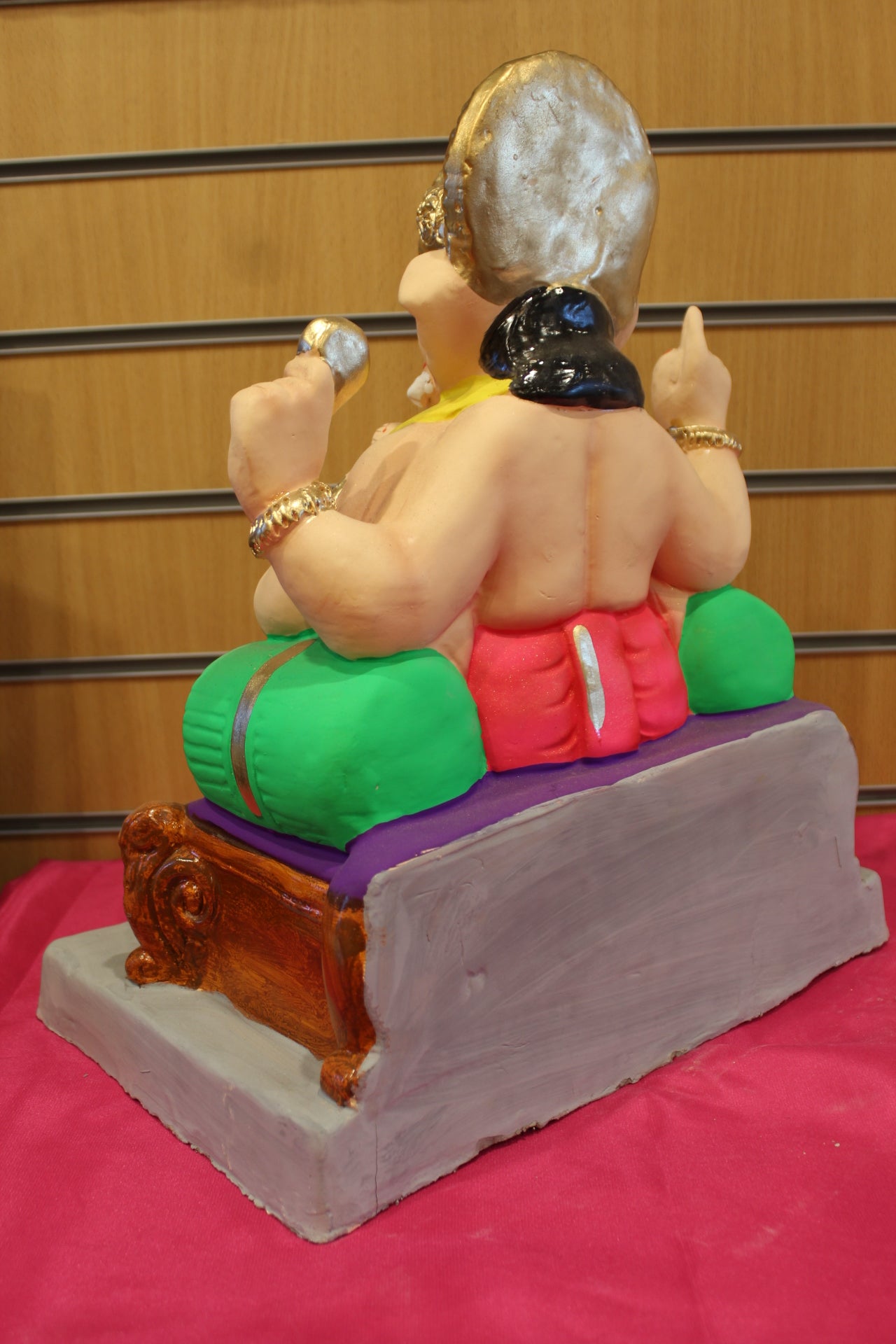 Back view – yellow khes and rani pink dhoti on scroll-legged chowki