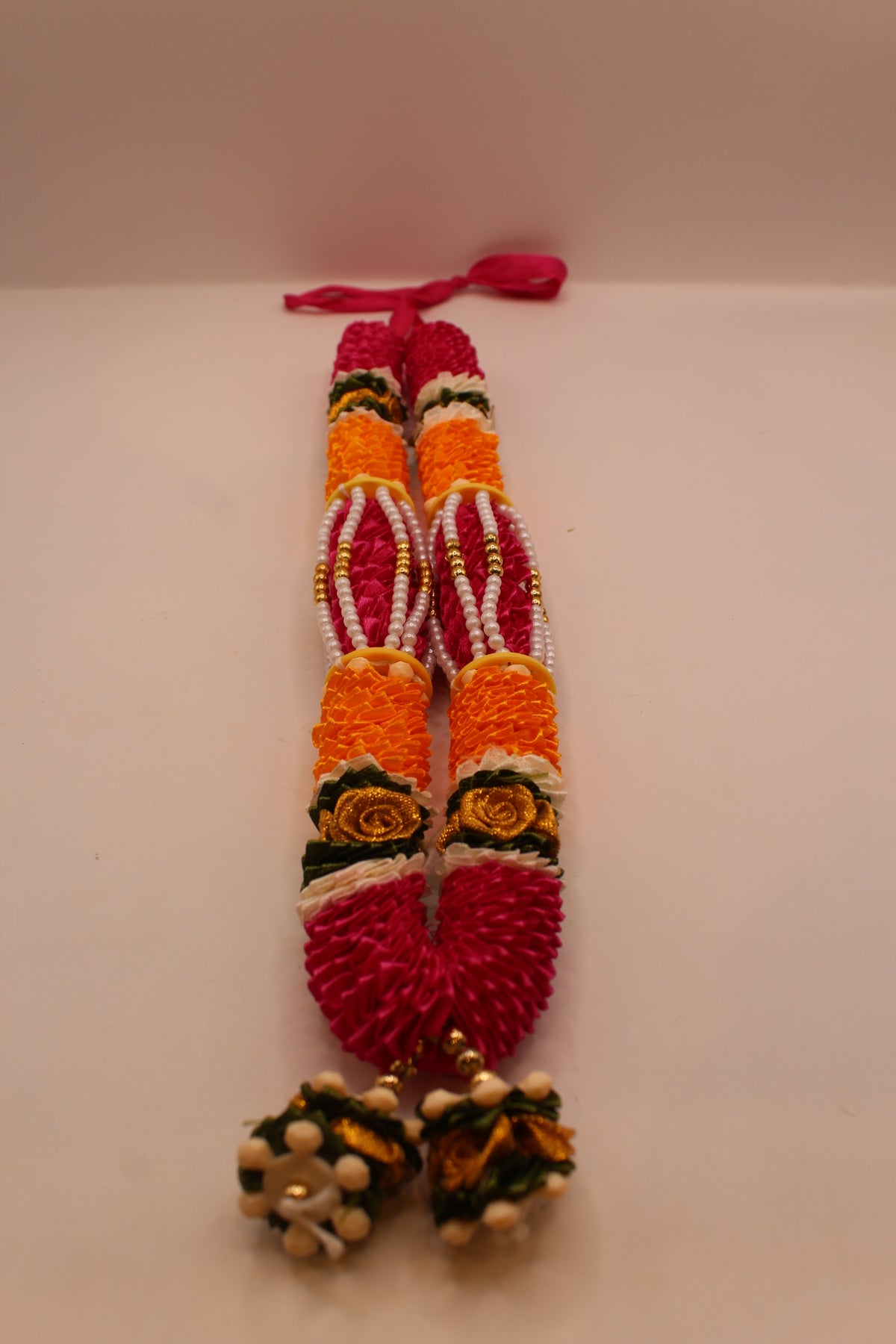Pink and yellow garland mala, close up