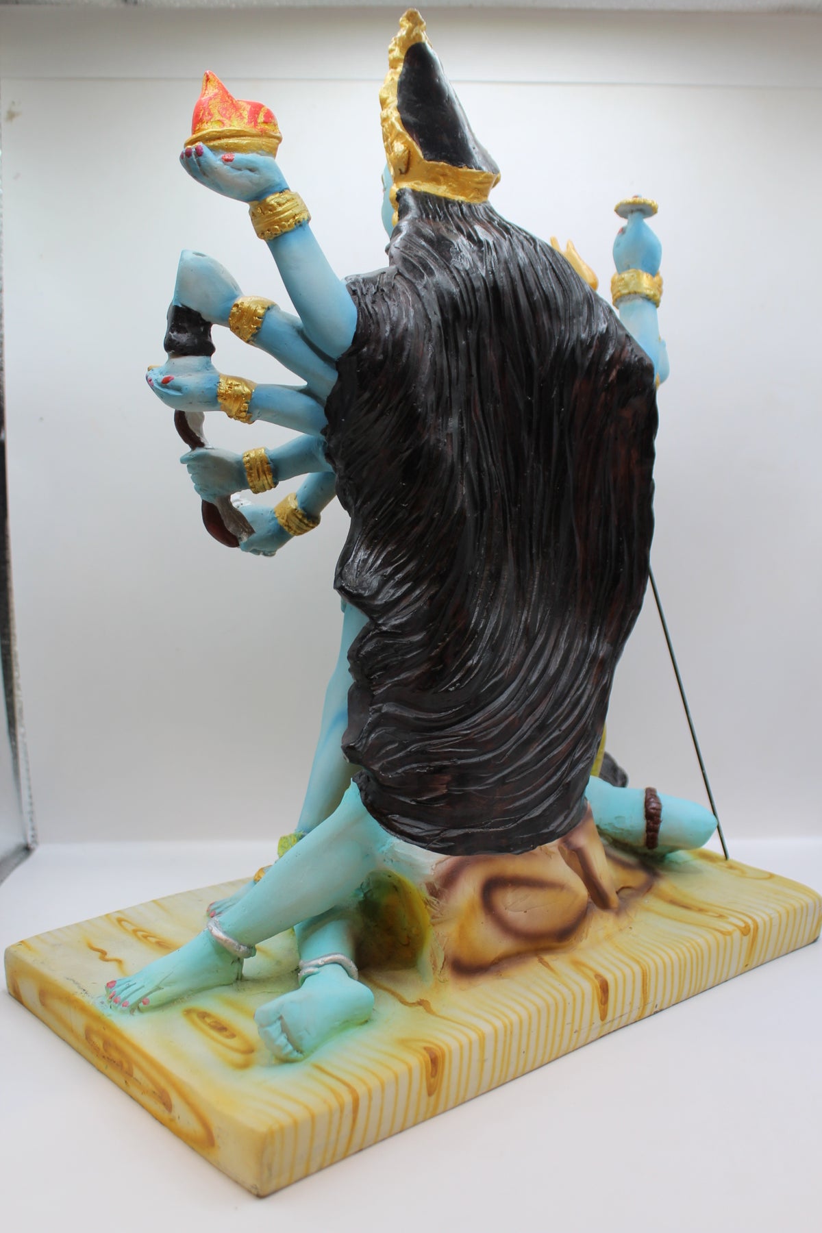 Resin Kali Mata statue, many arms, blue and gold, back view