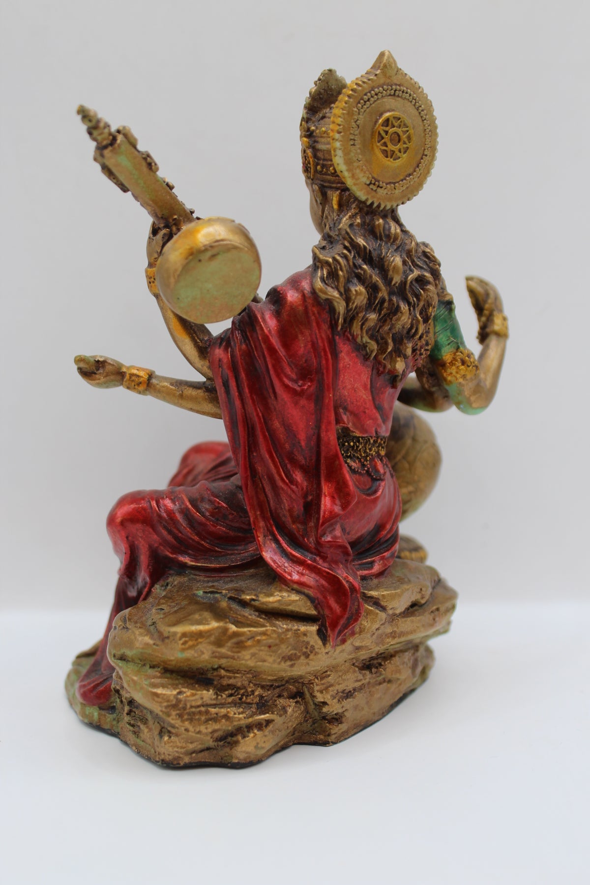 Resin Saraswati statue, playing veena, antique bronze, back view