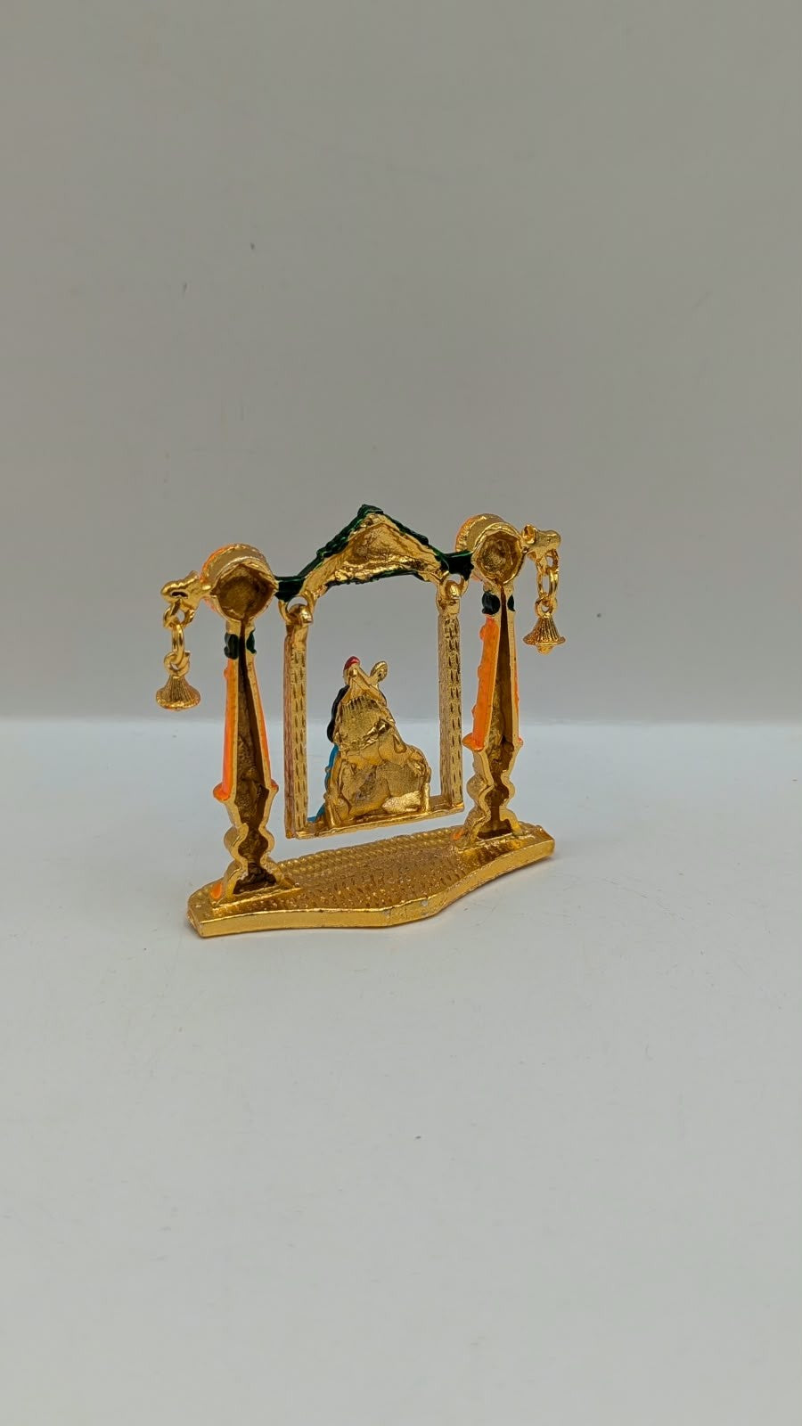 Bal Gopal on gold and orange jhula murti, back view