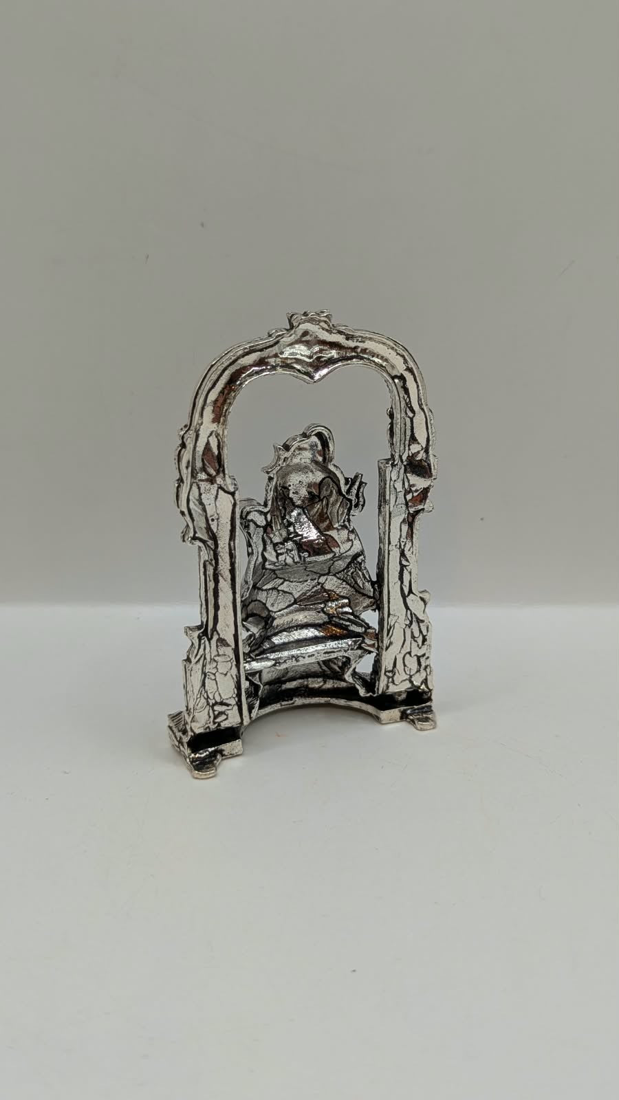 Silver Shiva murti in temple arch on lotus, back view