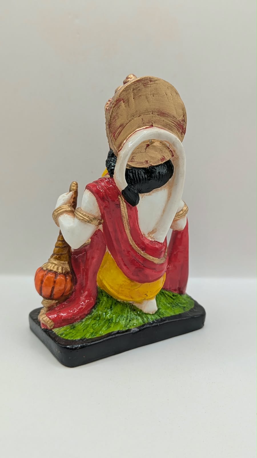 White and red kneeling Hanuman resin statue, back view