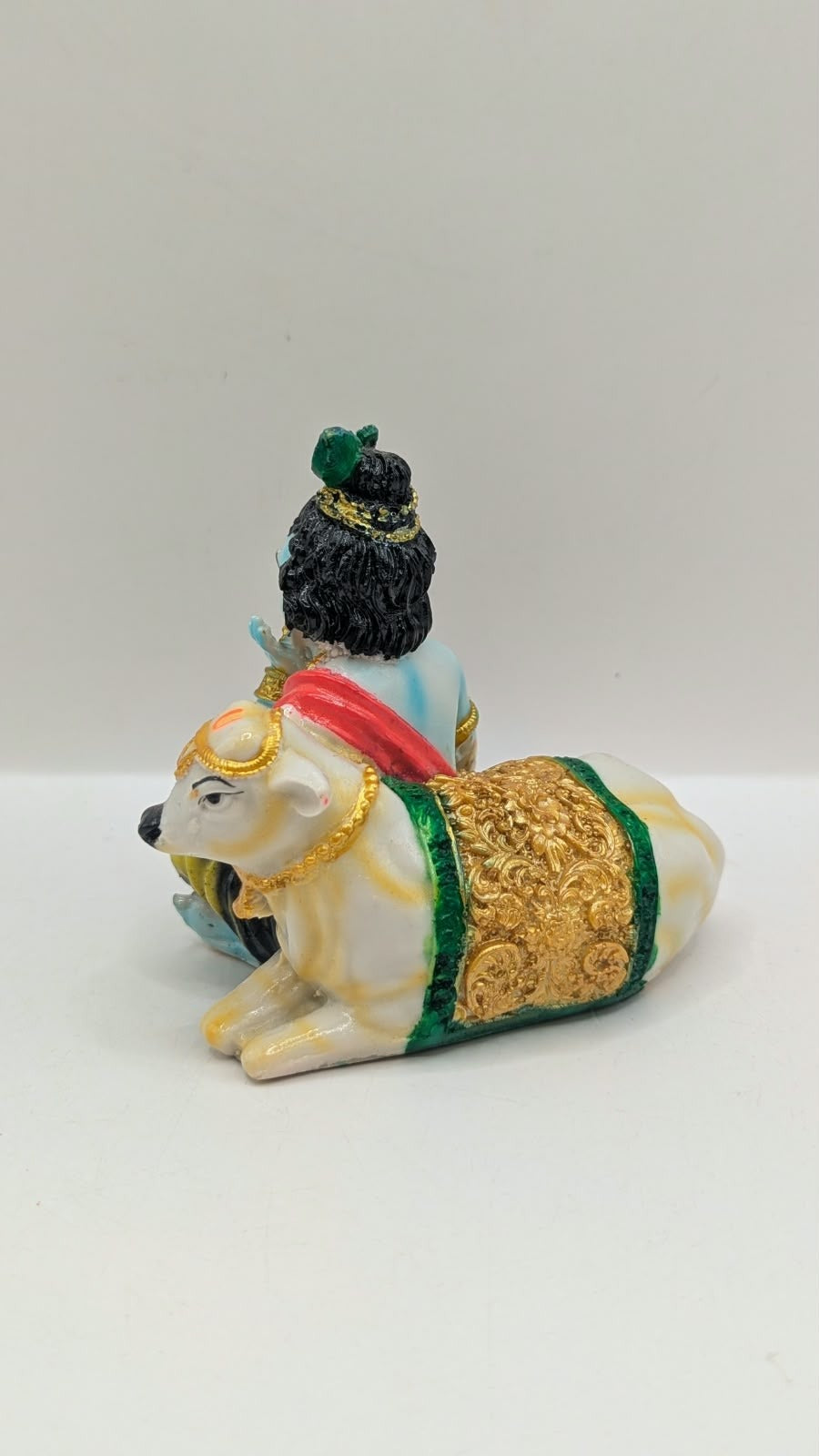 Krishna with cow statue, back view