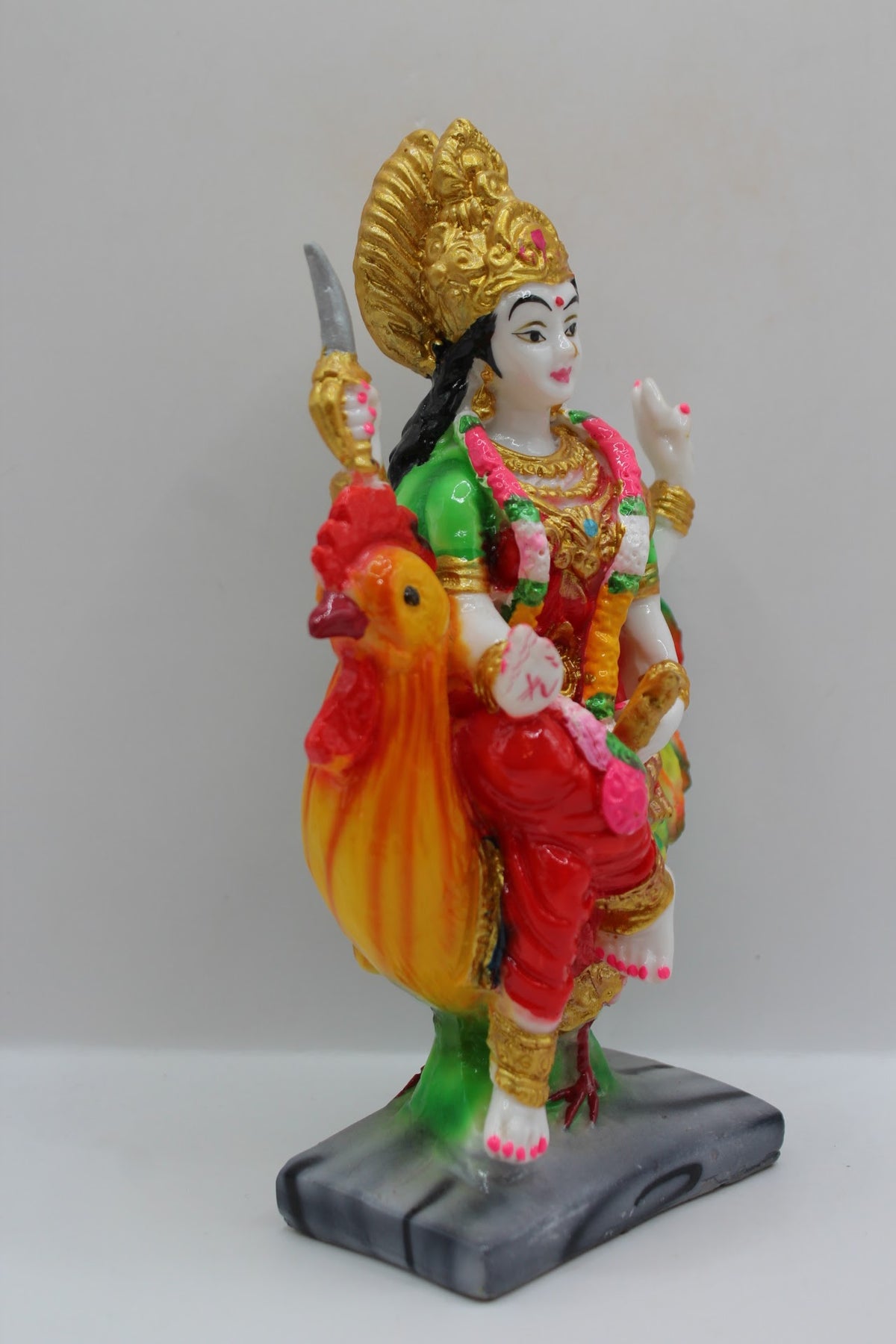 Resin Bahuchar Maa murti riding a rooster, left side view