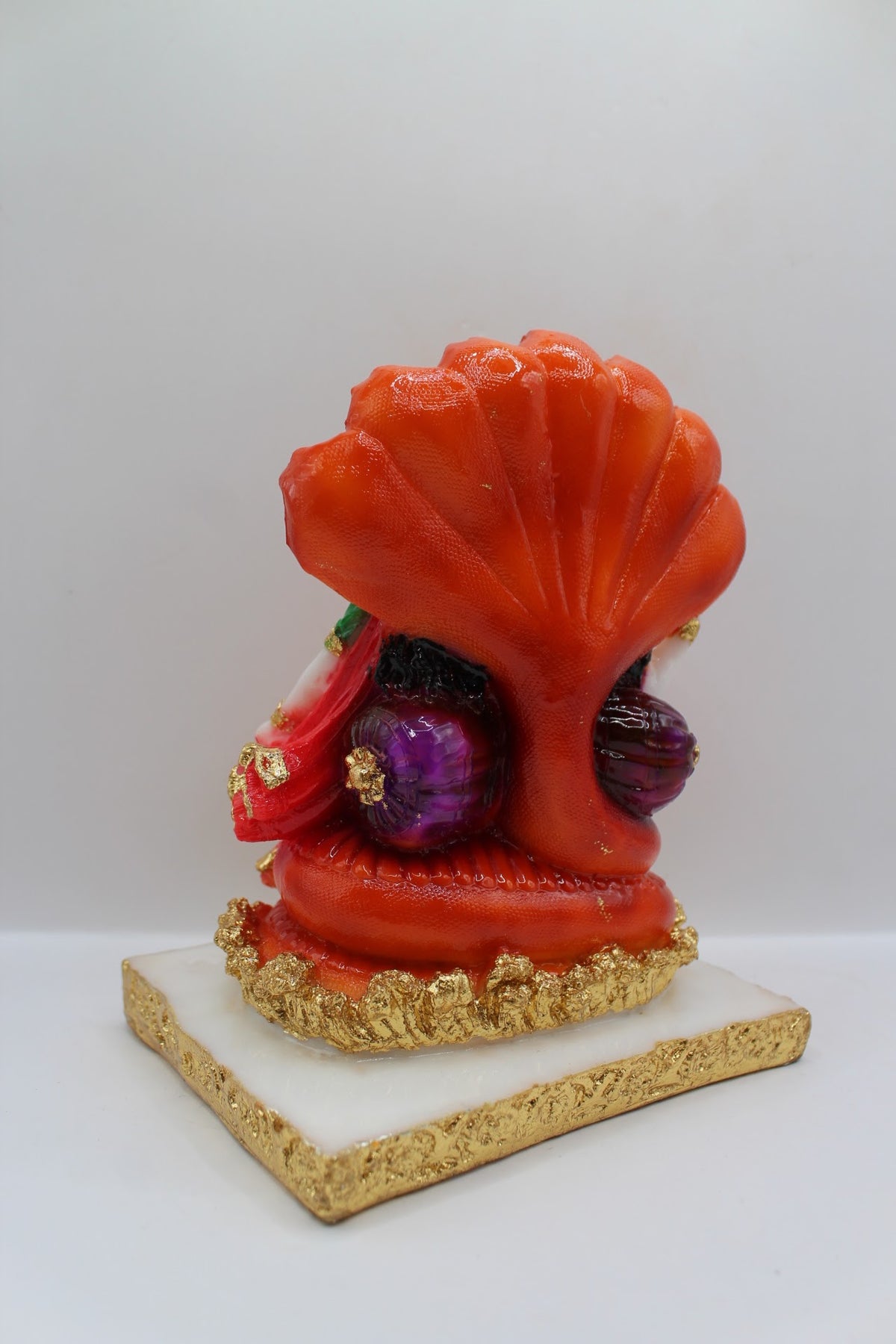 Red resin Vishnu Laxmi murti, seated under Sheshnaag, back view