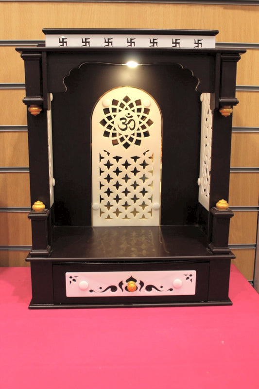 Dark wood open-front mandir with Om jali arch and lights, front view