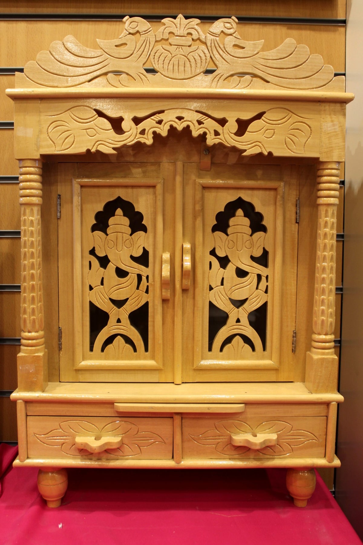 Carved Sevan wood mandir with jali doors closed, front view