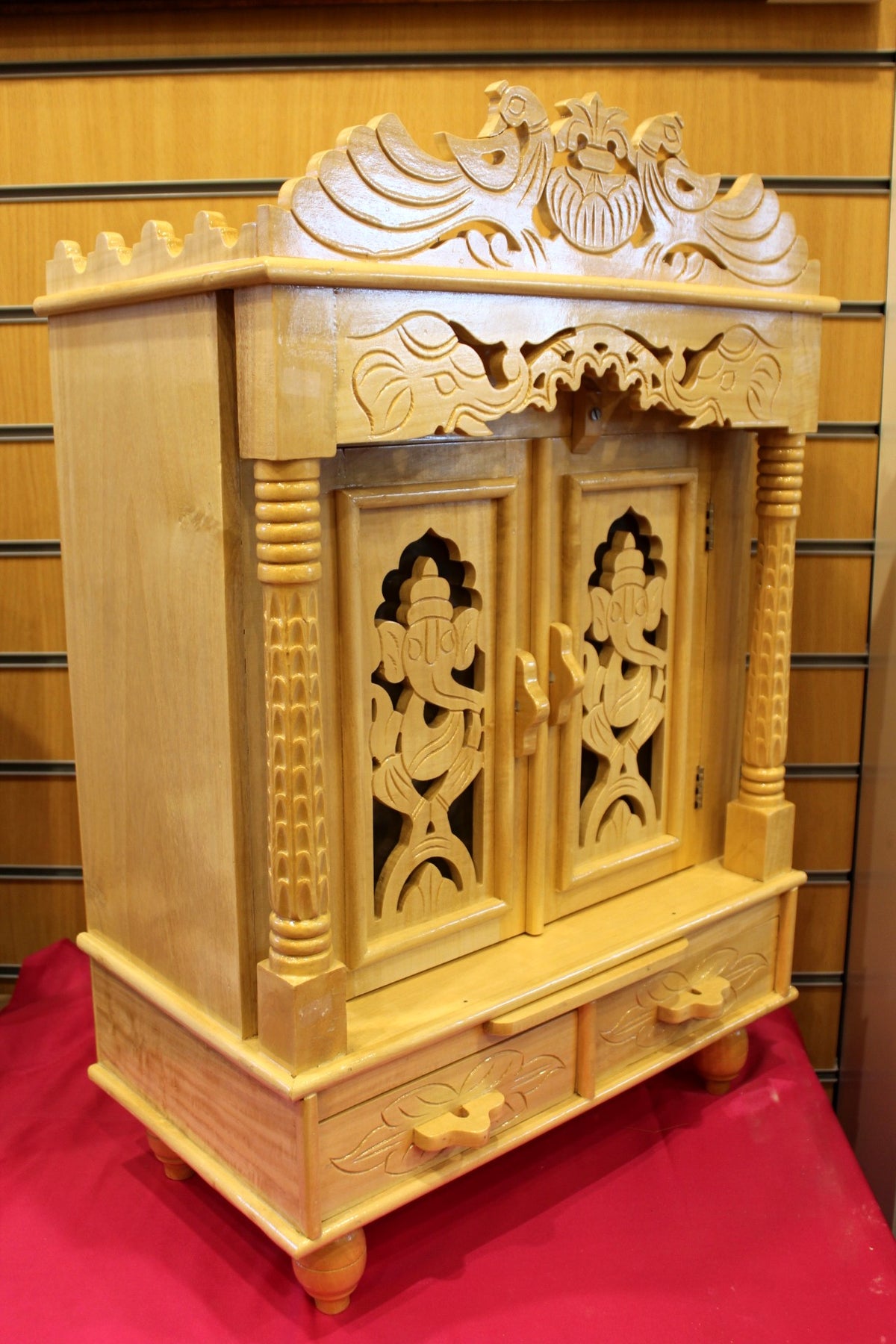 Sevan wood mandir with doors open showing the carved inner niche