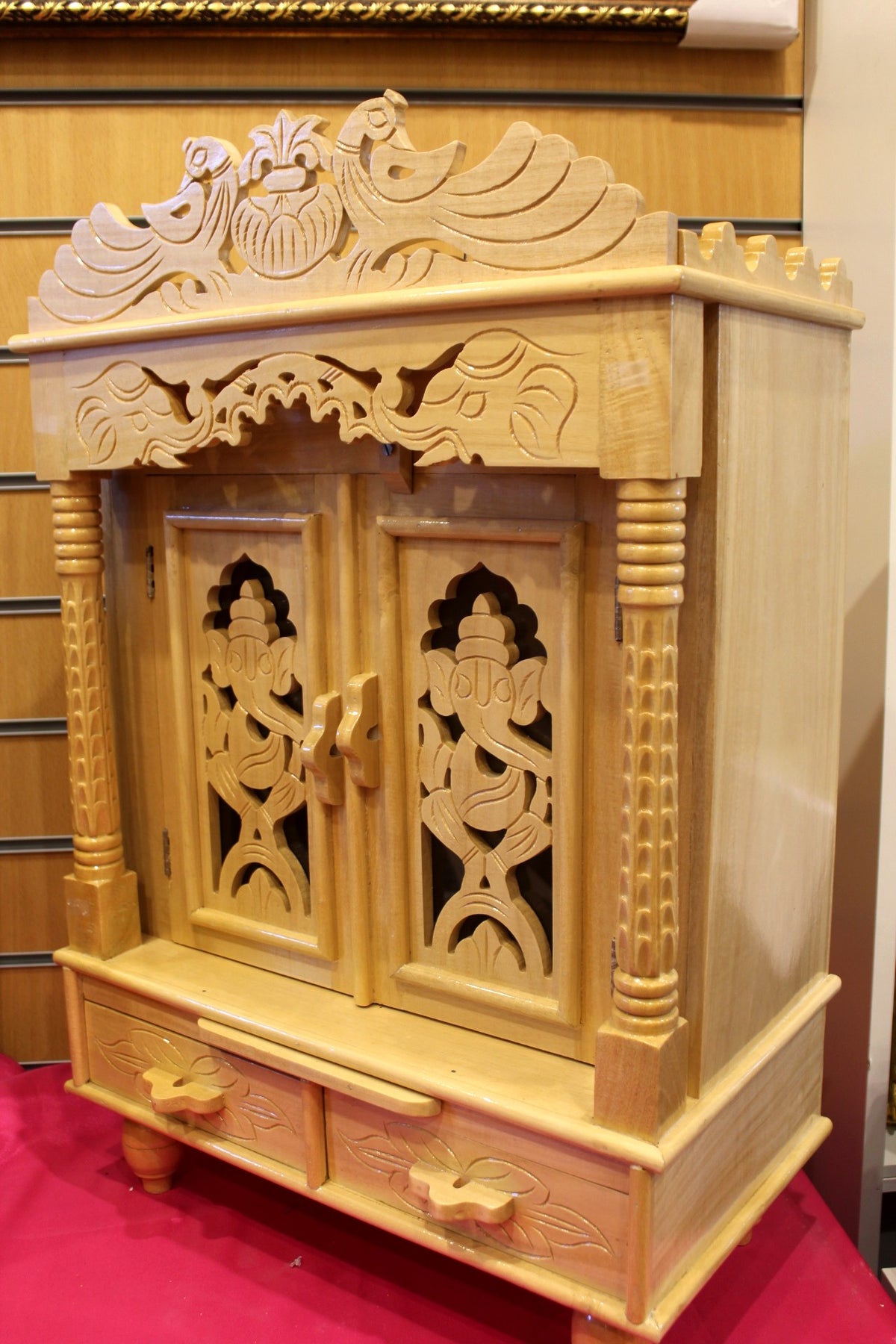Side angle of the Sevan wood mandir showing fluted pillars and depth