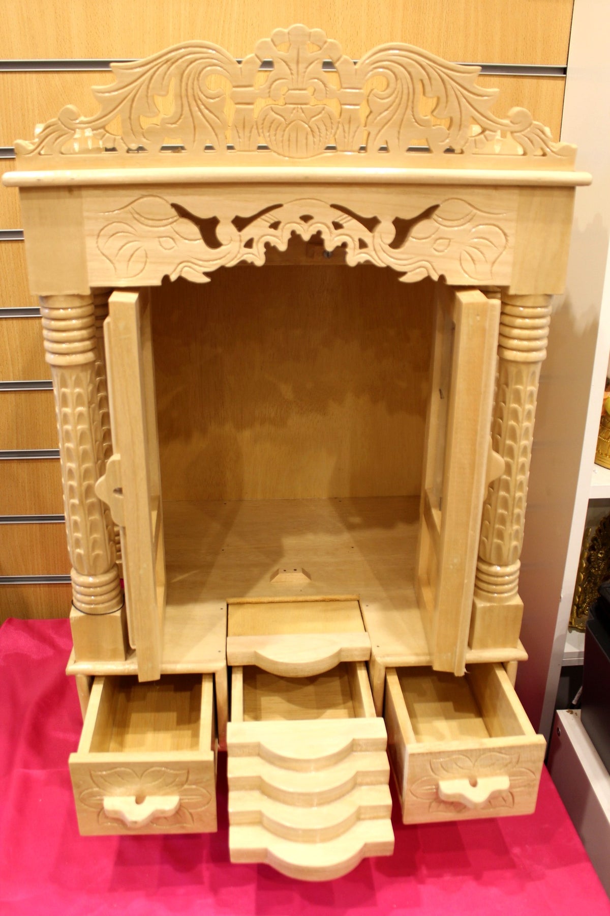 Three base drawers of the large Sevan wood mandir pulled open