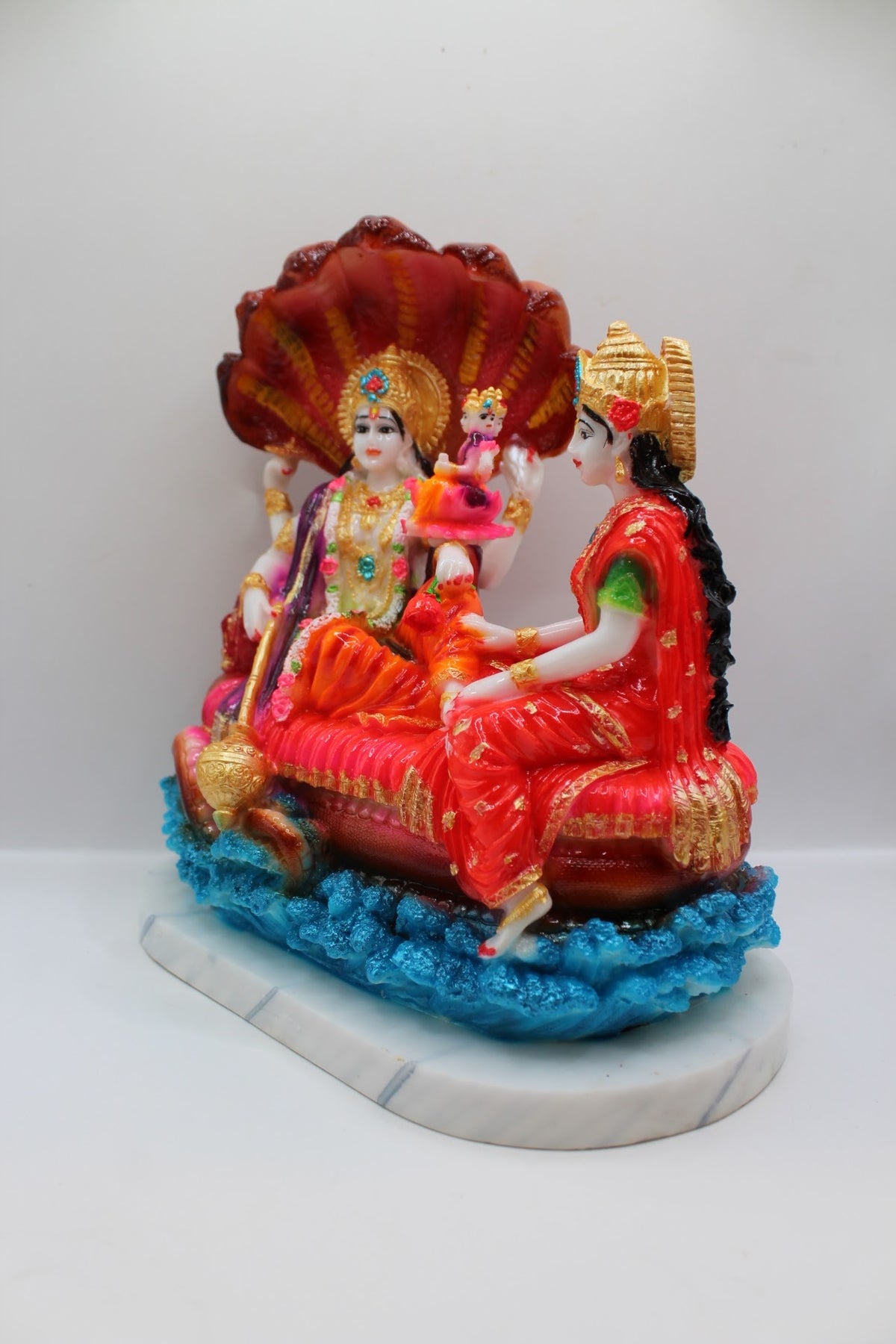 Colourful resin Vishnu Laxmi murti on Sheshnaag, right side view