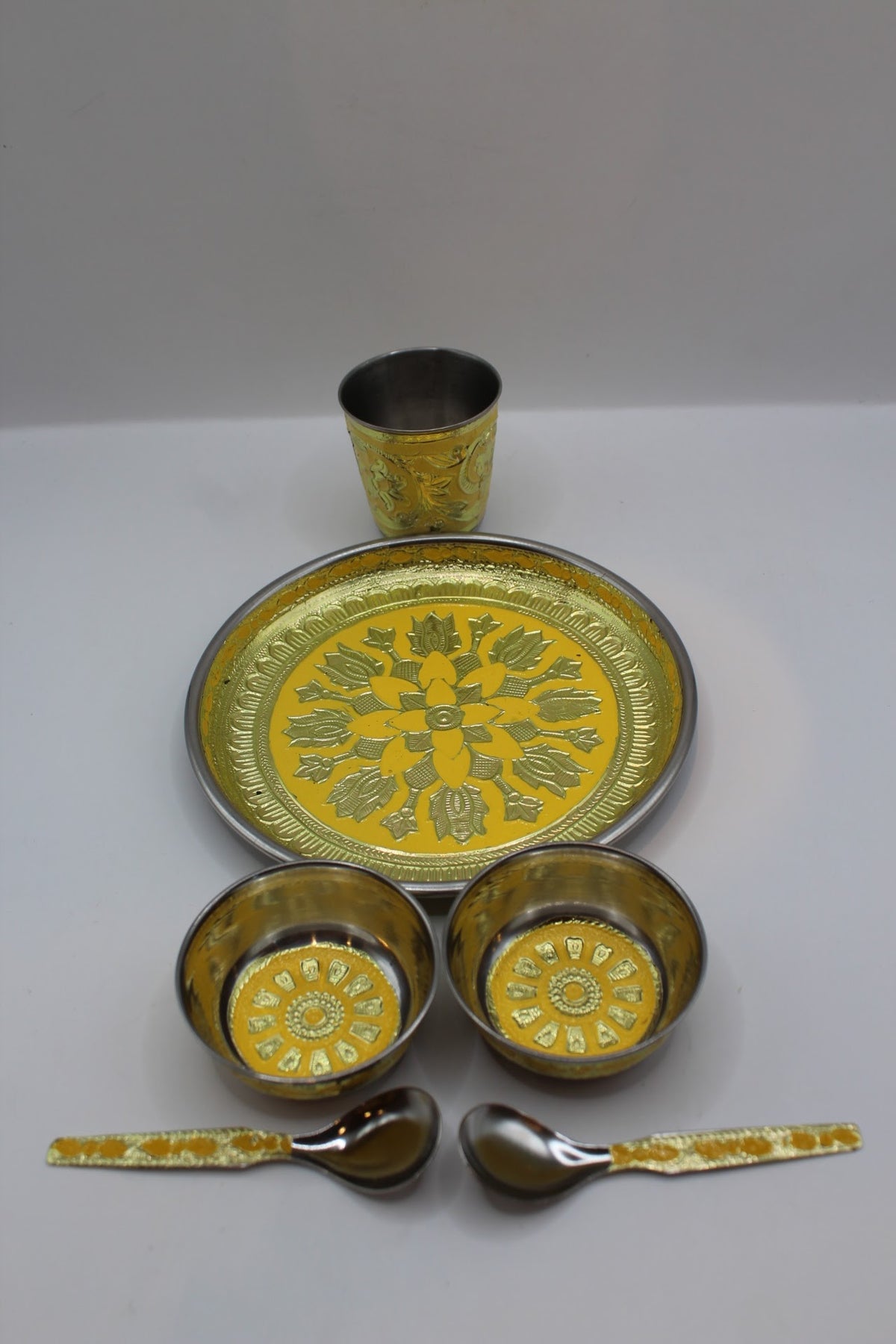 Gold pooja set No. 1 with thali, bowls, glass and spoons, side view