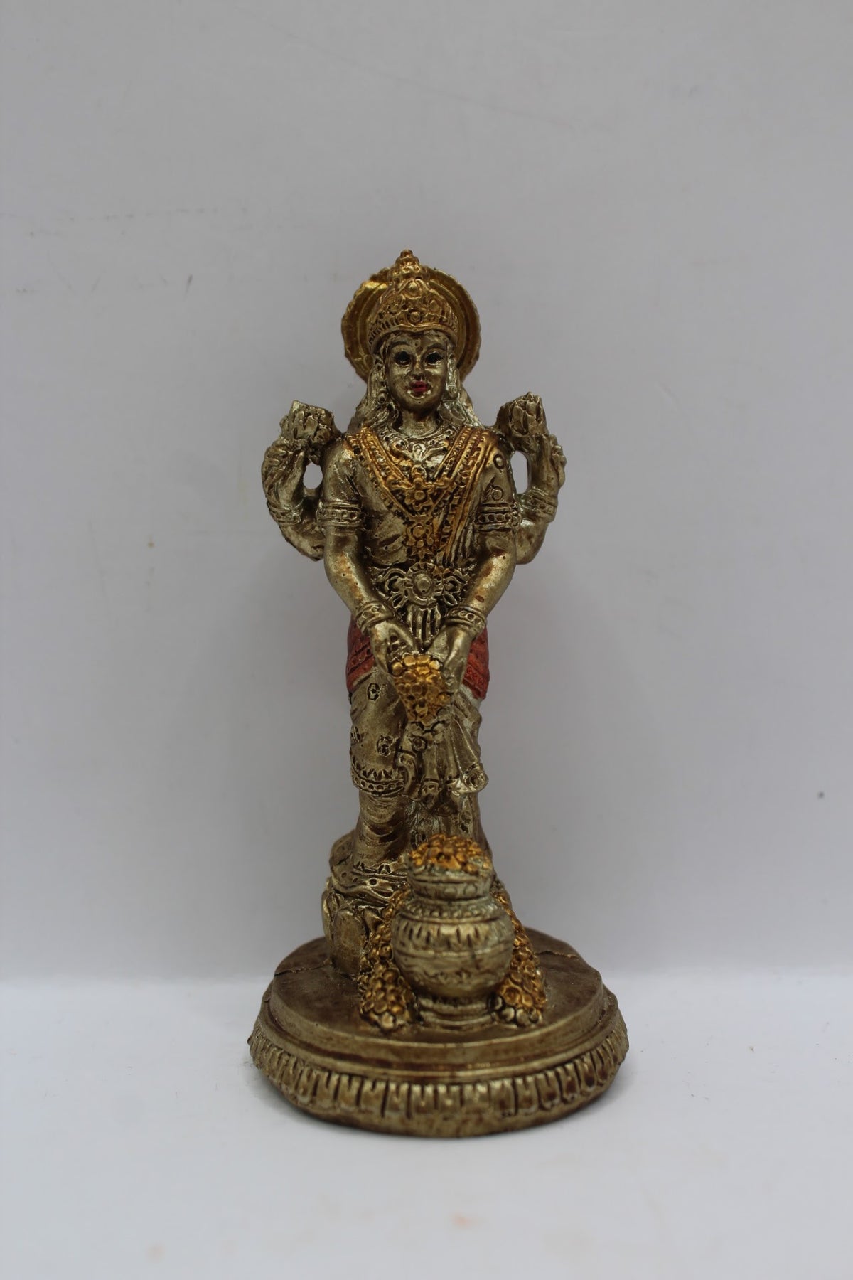 Small resin Laxmi murti standing with coin pot, front view