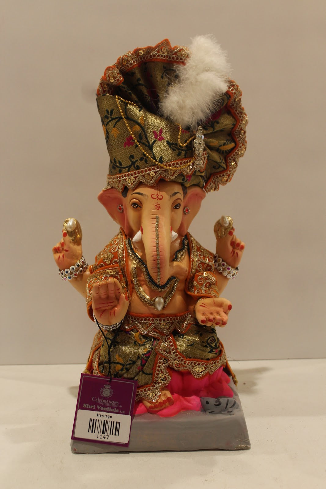 Eco-friendly clay Ganesh idol with green brocade safa and pink dhoti, front view