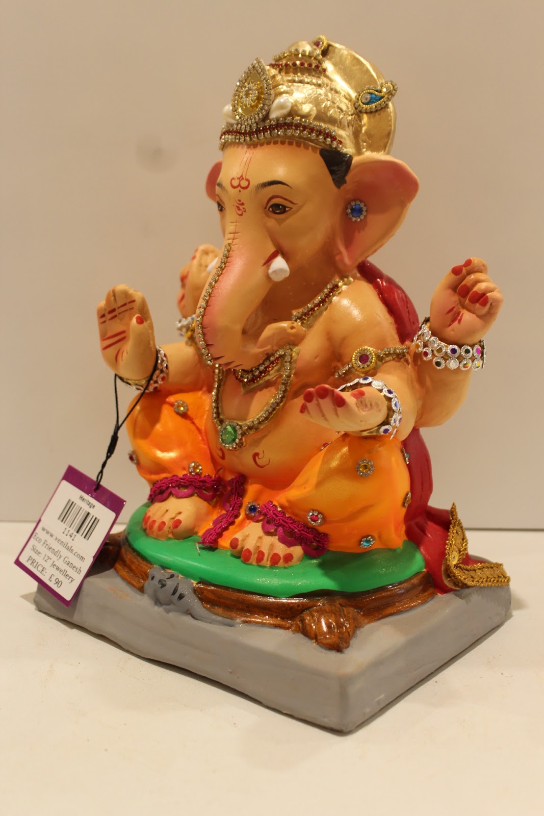 Eco-friendly clay Ganesh idol in jewellery style with blue gem crown, side view