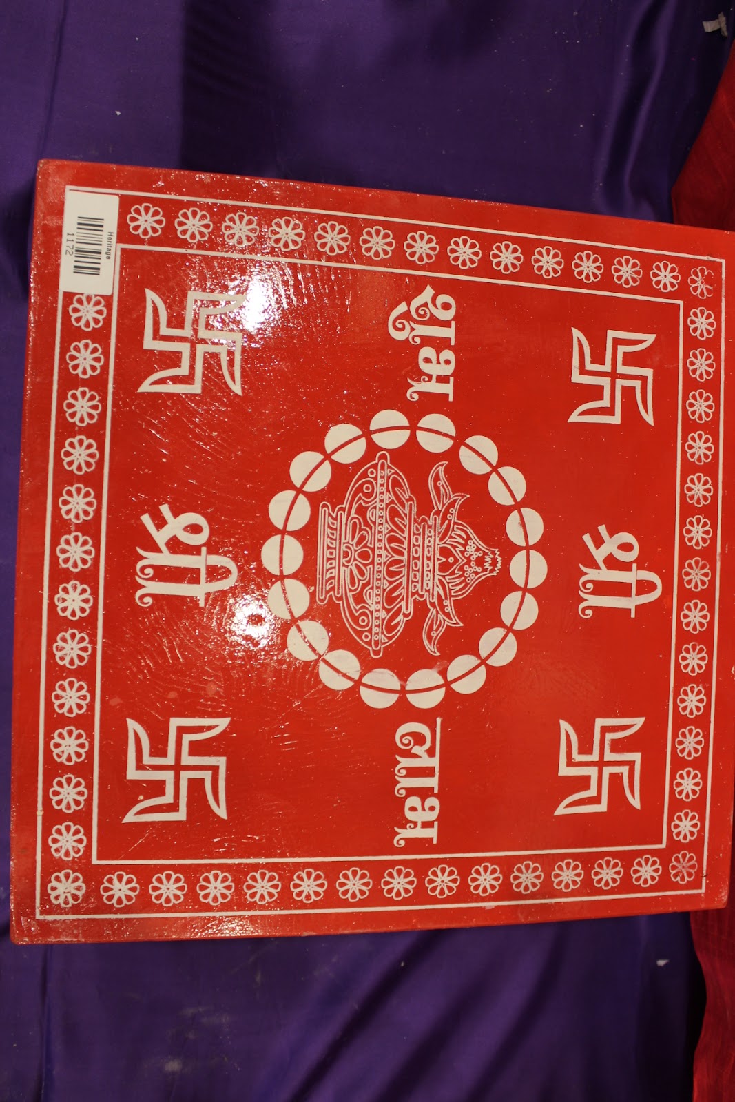 Red wooden bajot pooja chowki detail of block-printed top