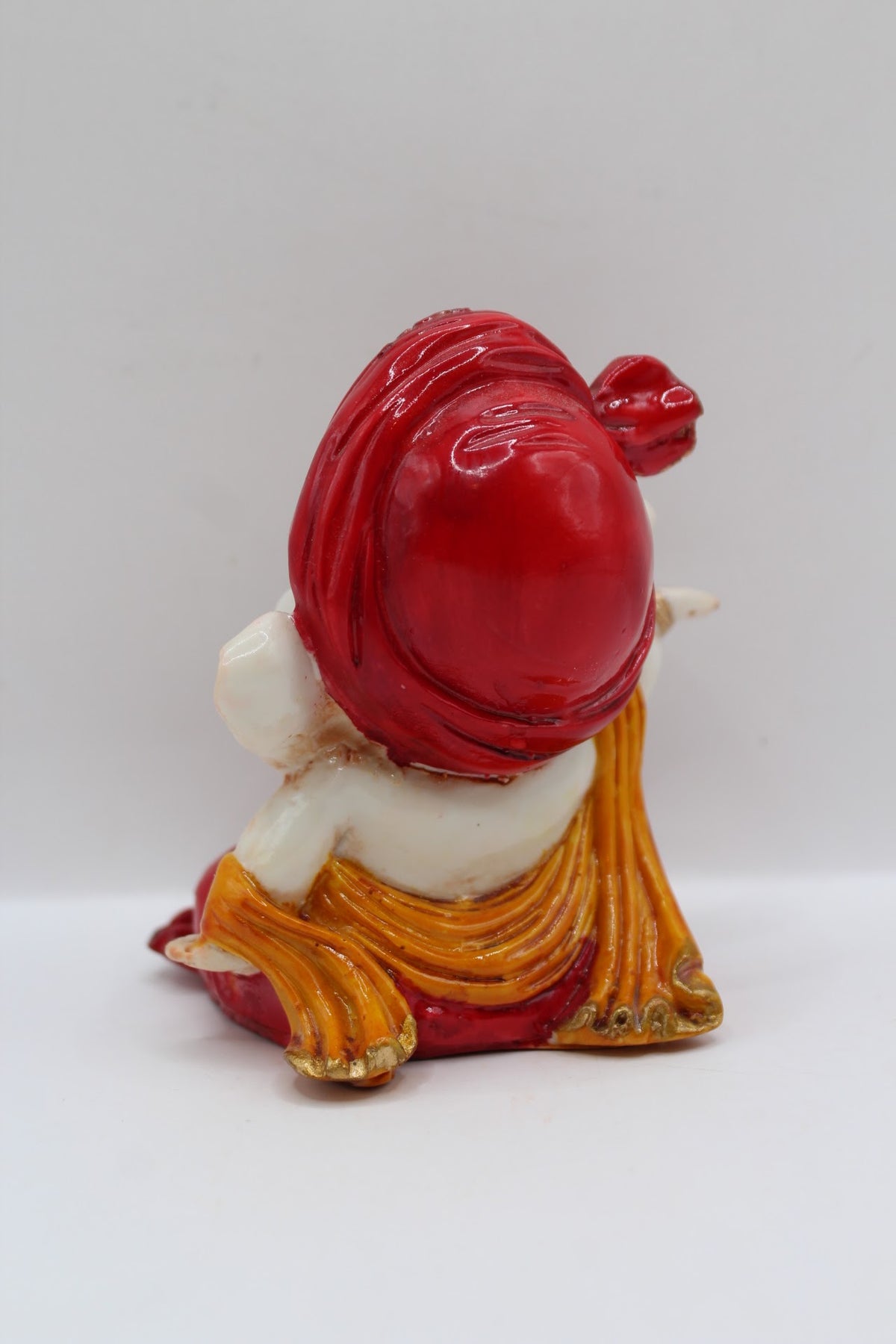 Baby Ganesh murti, red turban and red dhoti, back view