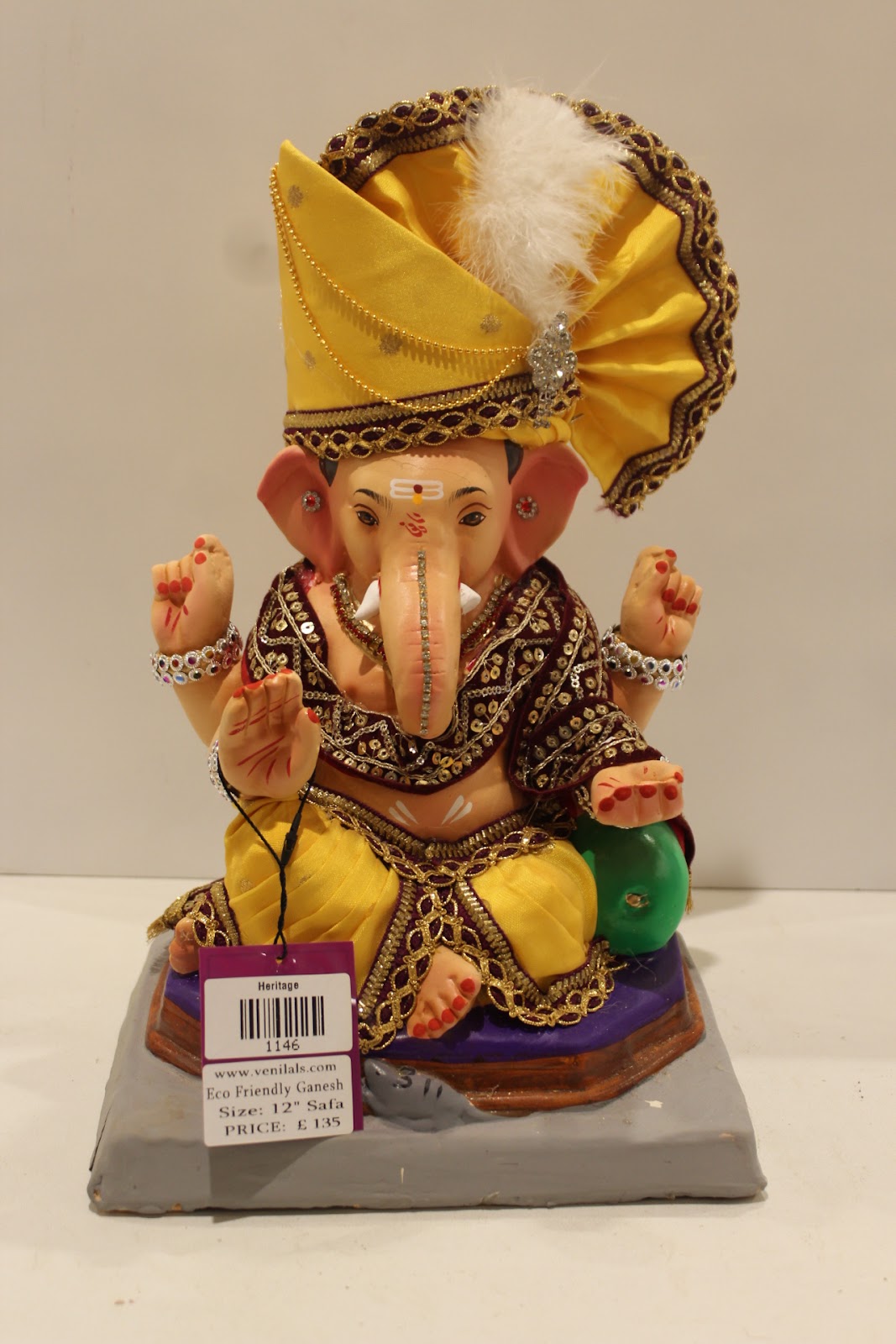Eco-friendly clay Ganesh idol with yellow pheta and maroon embroidered robe, front view