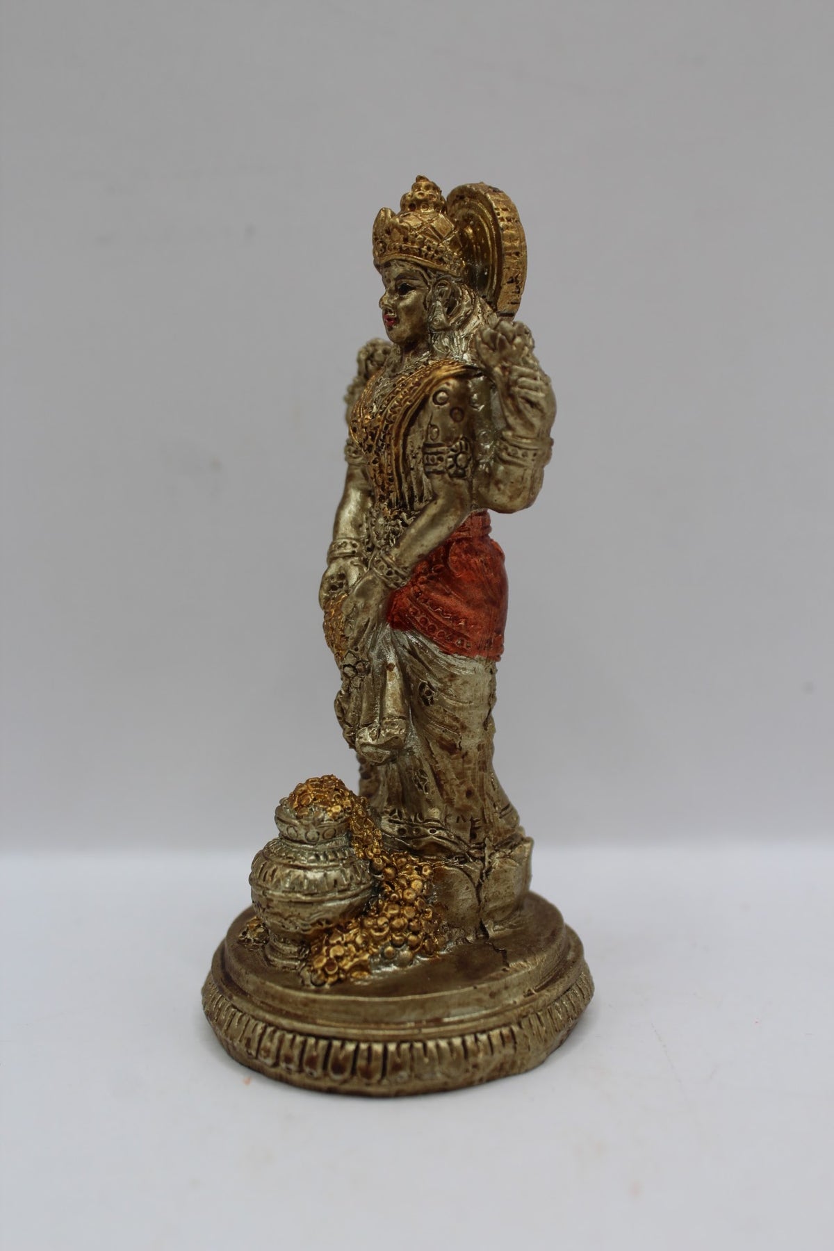 Small resin Laxmi murti standing with coin pot, right side view