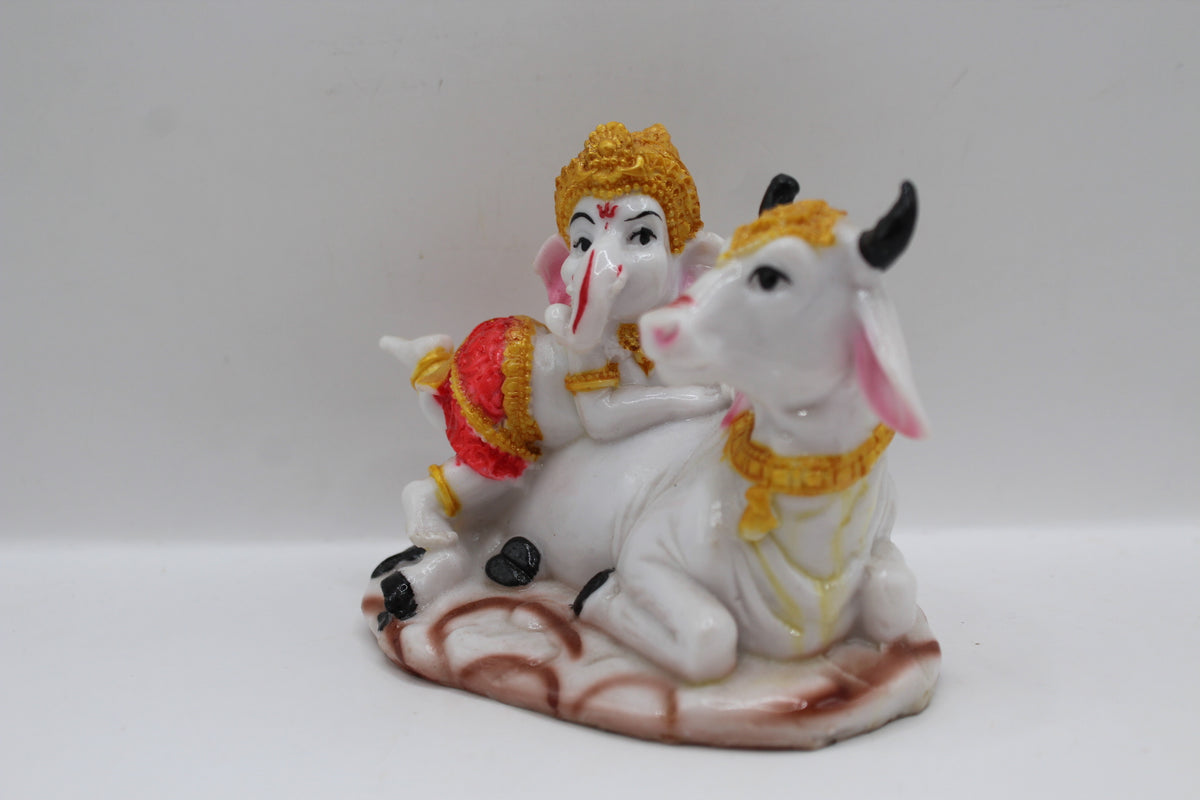 Baby Ganesh murti with white cow, right side view