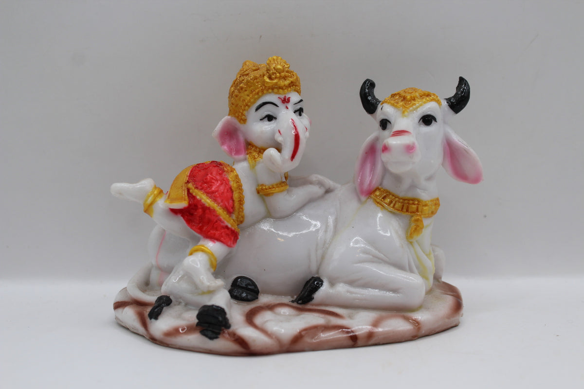 Baby Ganesh murti with white cow, front view