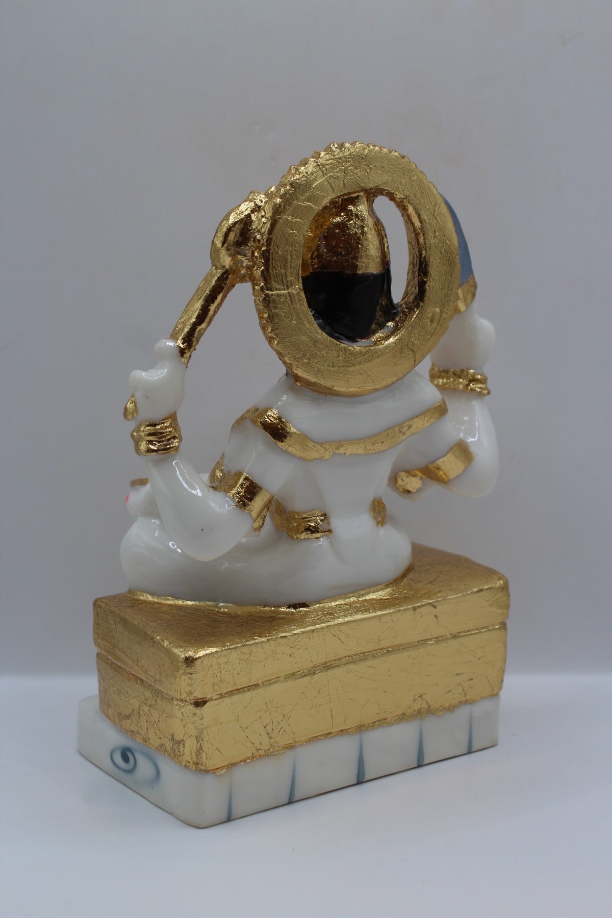 White and gold resin Santoshi Maa murti, back view