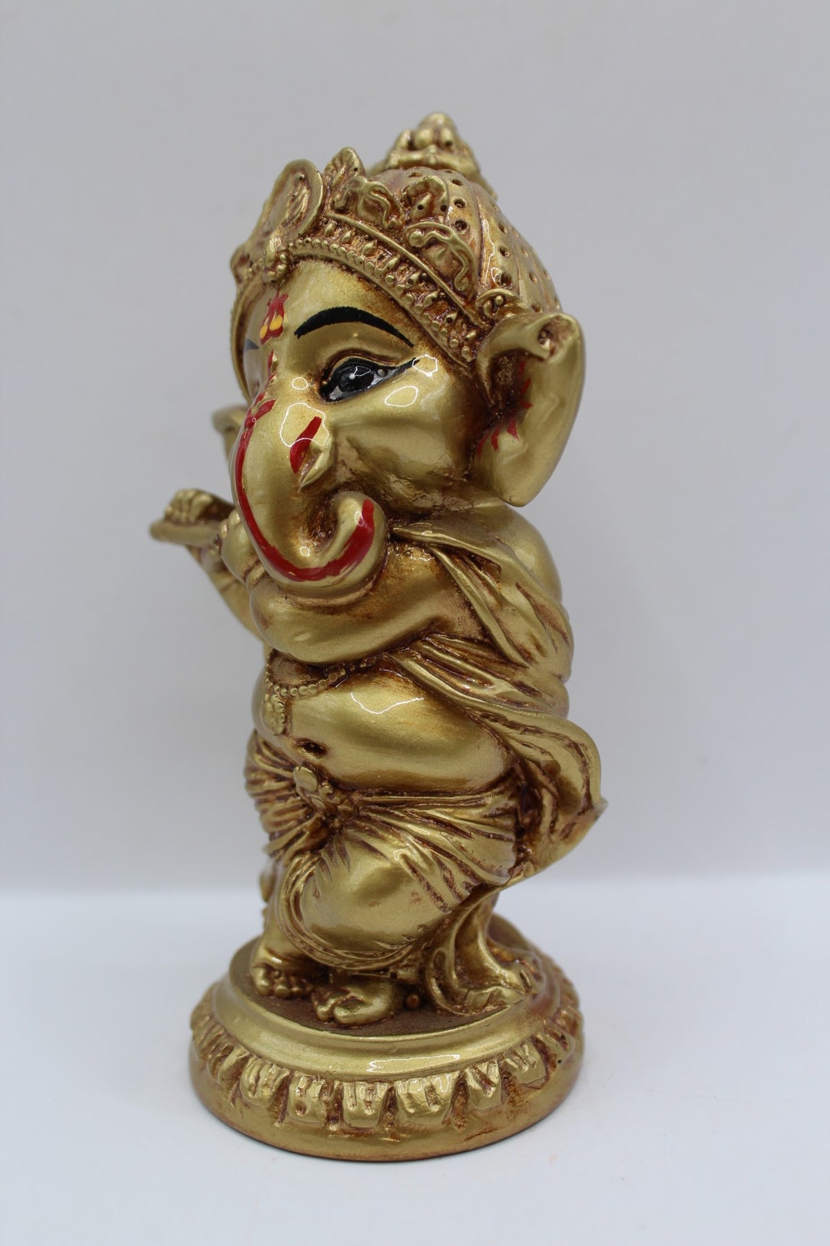 Gold resin Ganesh murti standing, playing flute, right side view