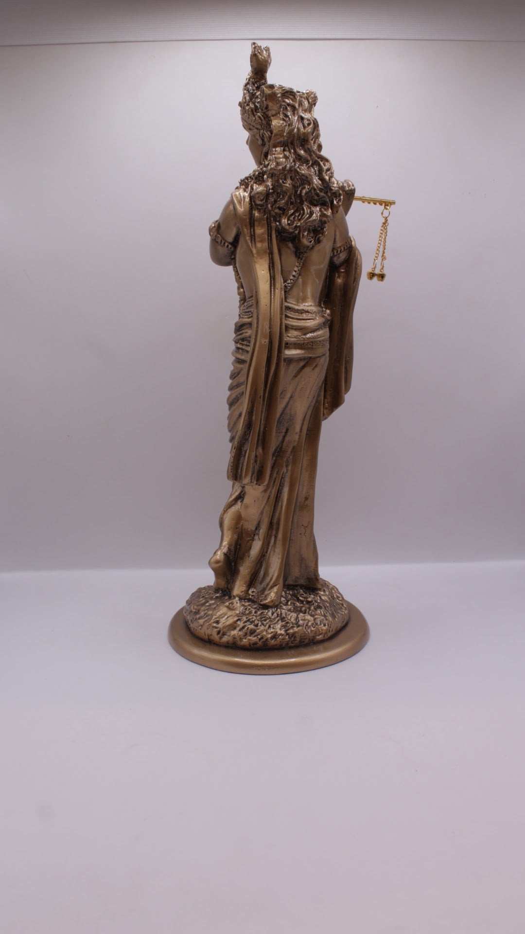 Antique bronze resin Krishna statue playing flute, back view