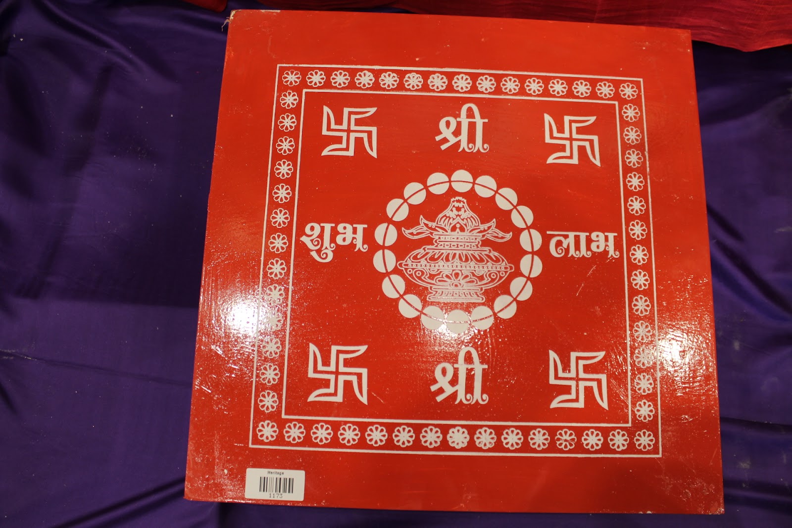 Red wooden bajot pooja chowki detail of block-printed top