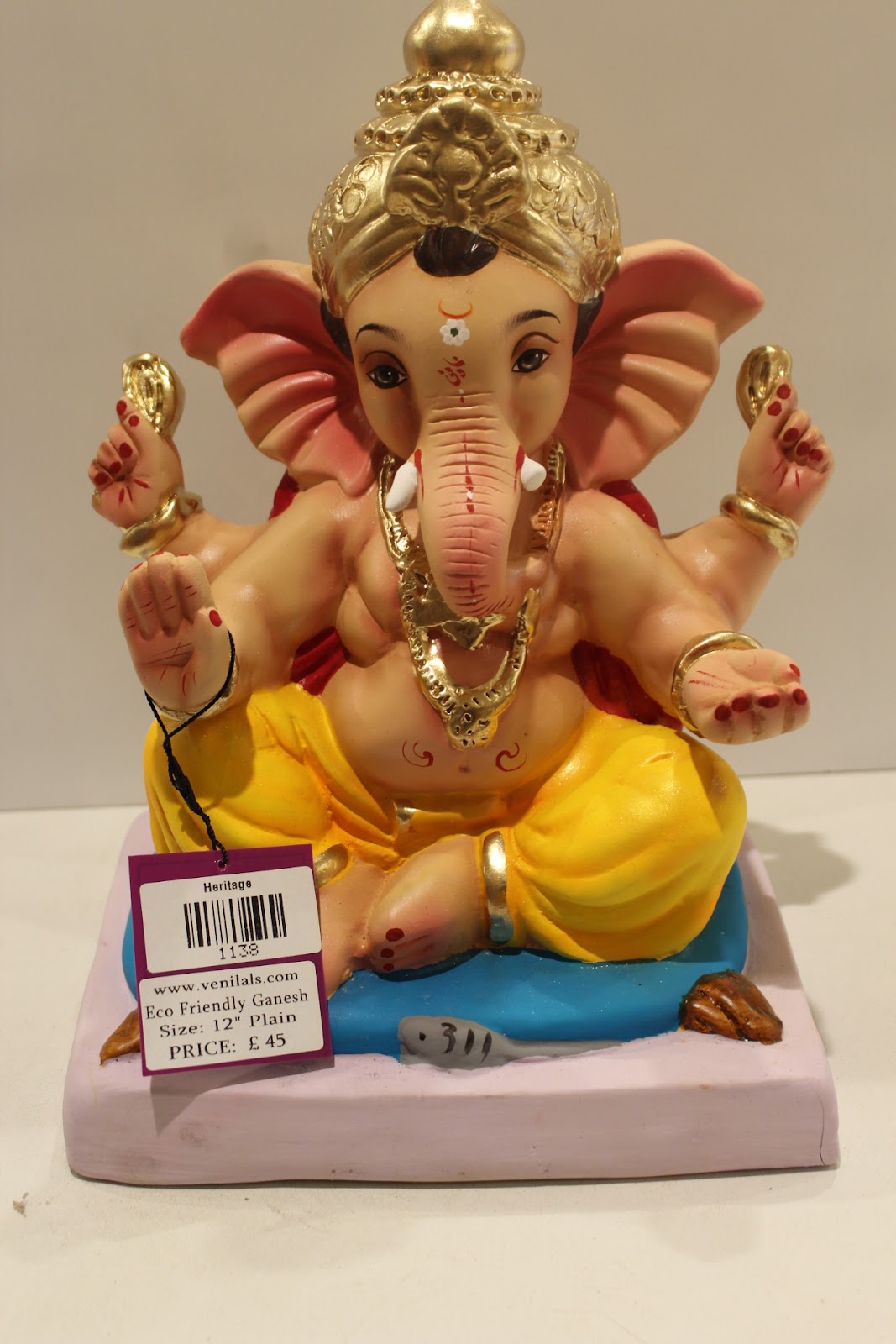 Eco-friendly clay Ganesh idol with red khes and yellow dhoti, front view