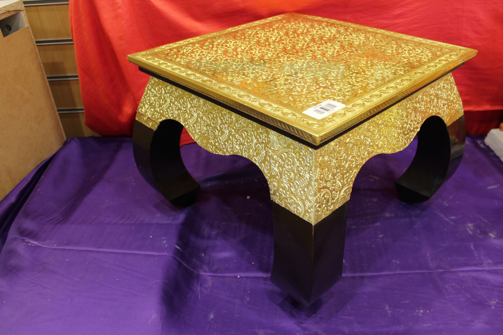 Tall premium gold embossed bajot pooja chowki angled view with curved black legs
