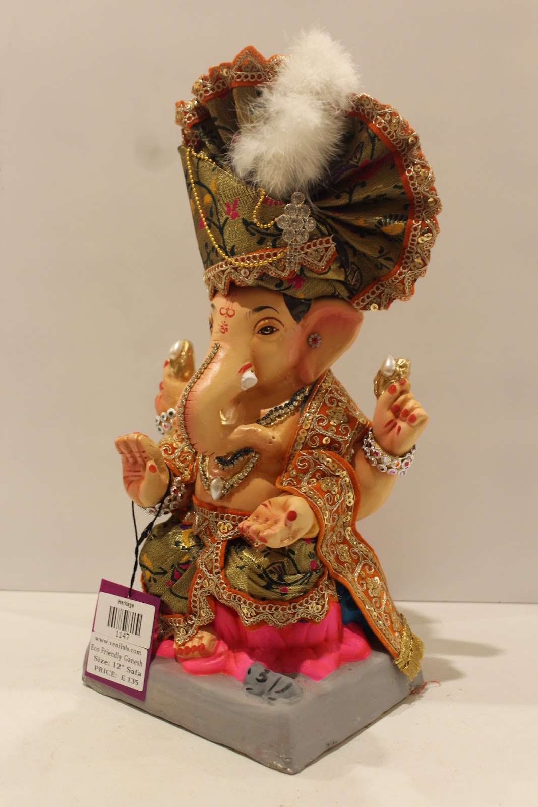 Eco-friendly clay Ganesh idol with green brocade safa and pink dhoti, side view