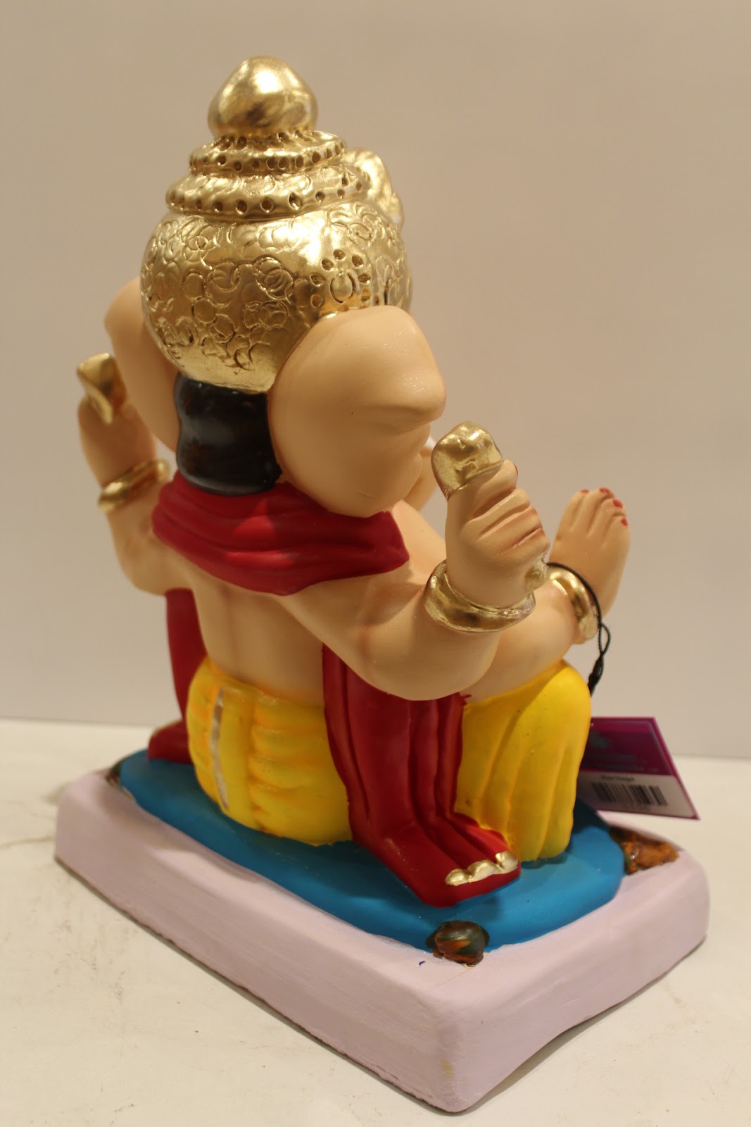 Eco-friendly clay Ganesh idol with red khes and yellow dhoti, back view