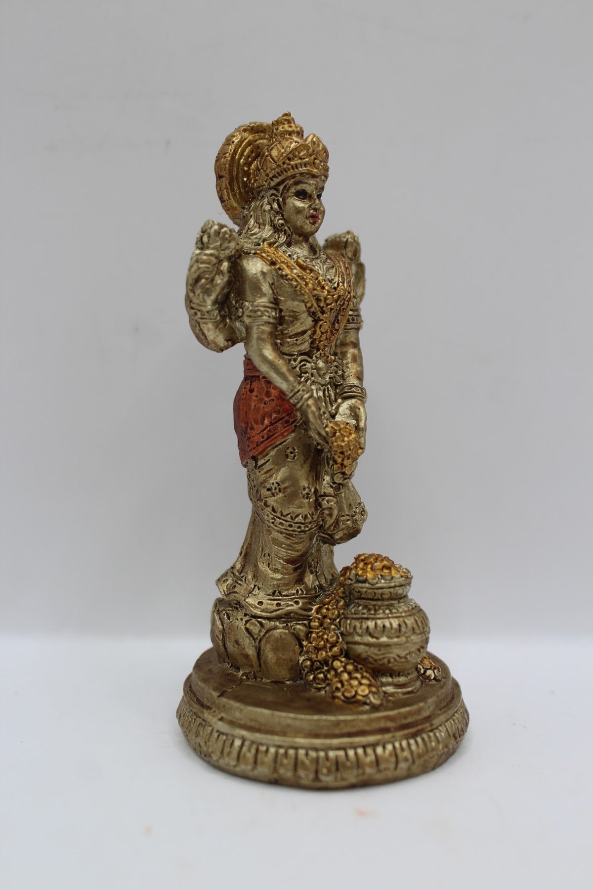 Small resin Laxmi murti standing with coin pot, left side view