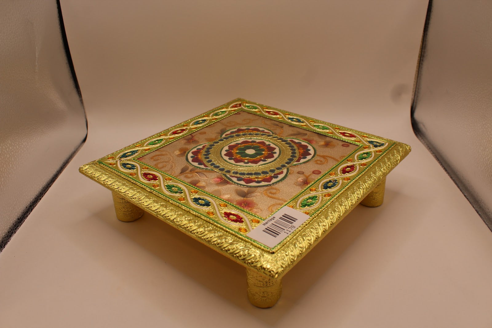 Floral meenakari chowki angled view with gold cylindrical legs