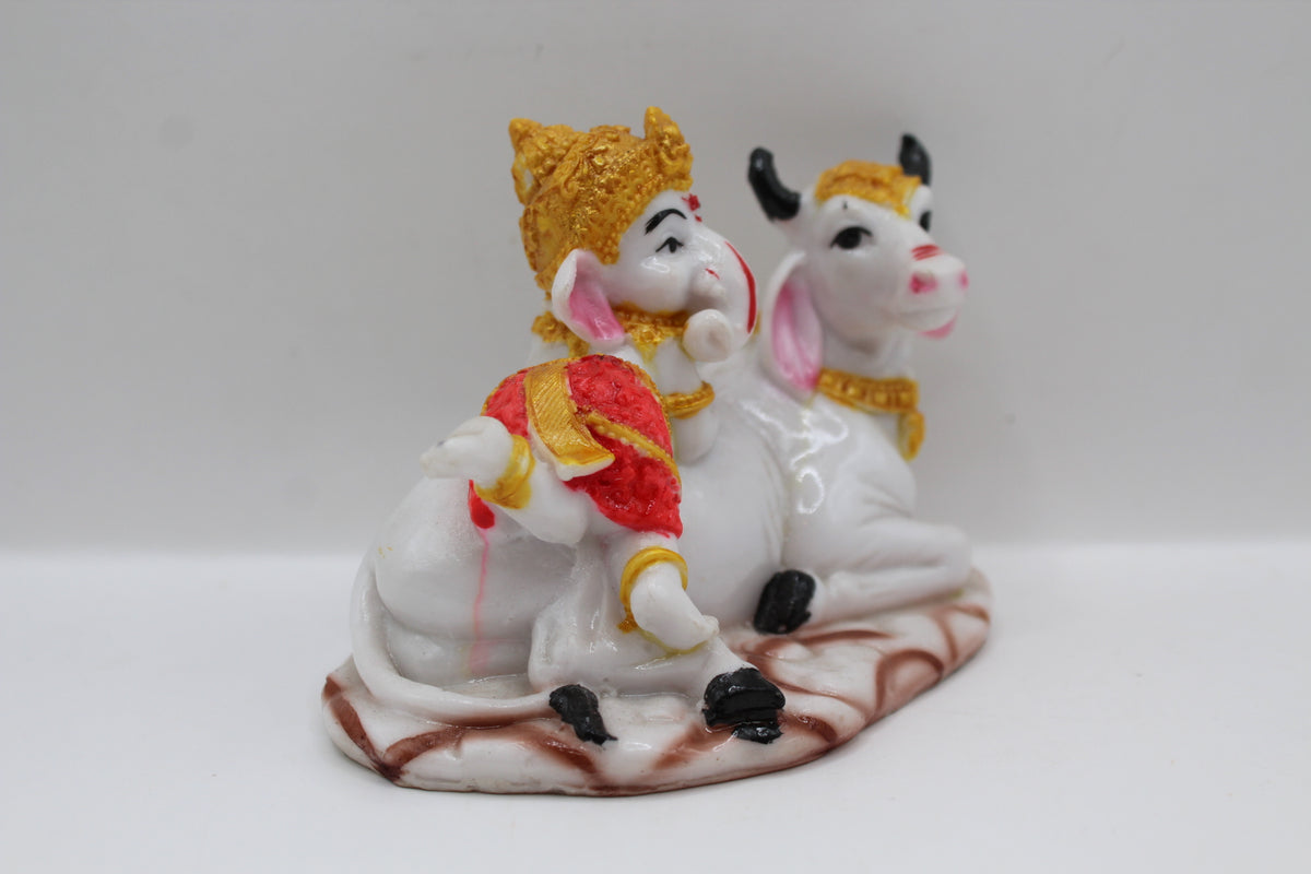 Baby Ganesh murti with white cow, left side view