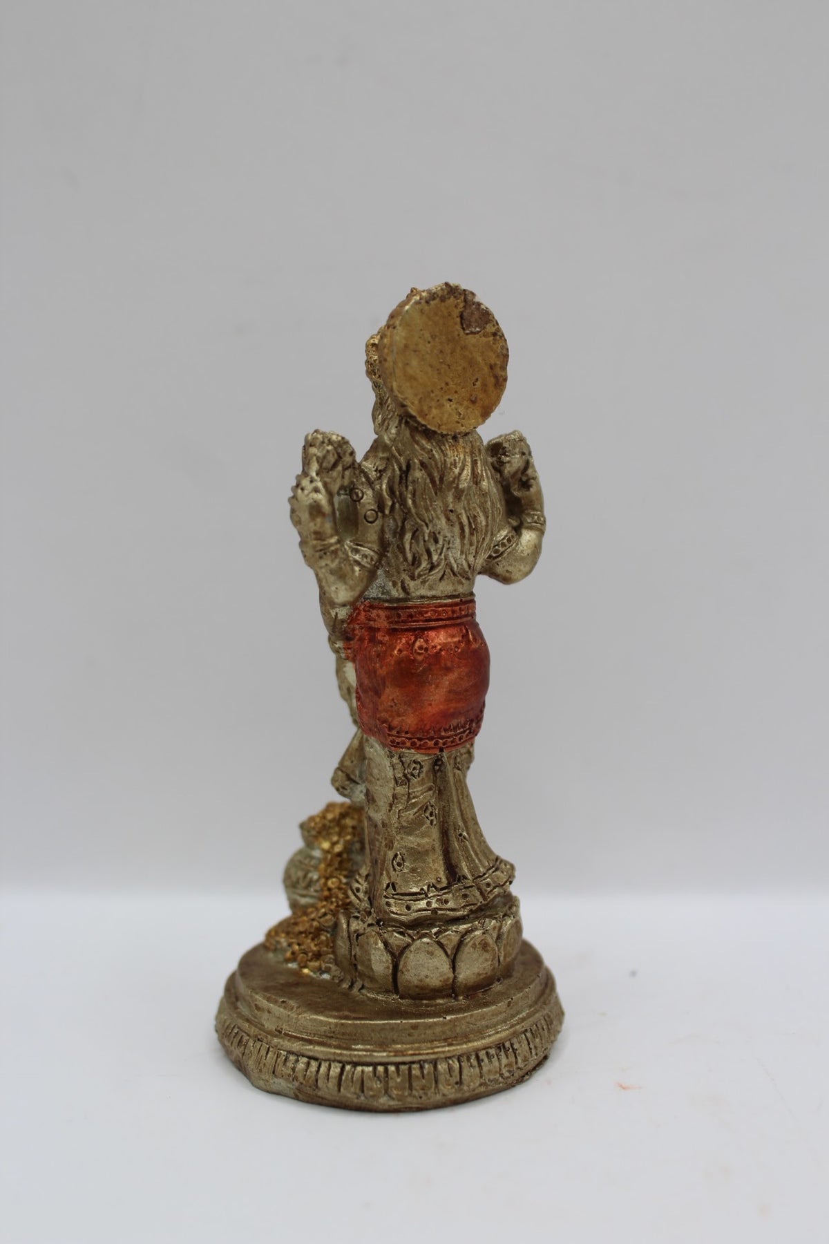 Small resin Laxmi murti standing with coin pot, back view