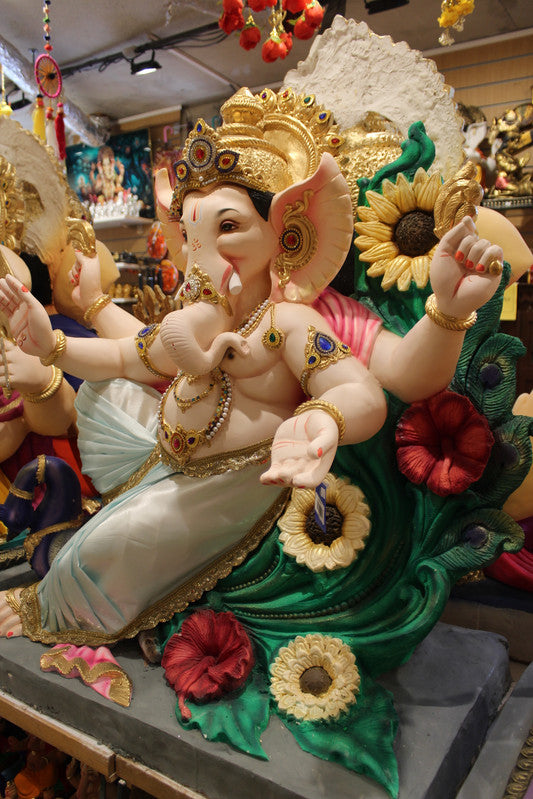 POP Ganesh Visarjan idol, dancing pose with floral peacock backdrop, close-up