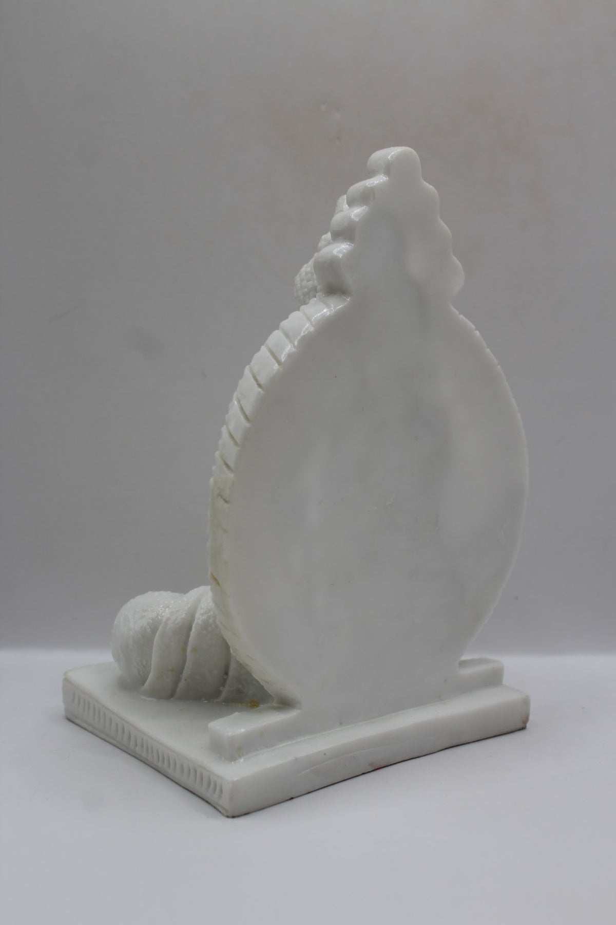 White resin Buddha statue meditating with halo, back view