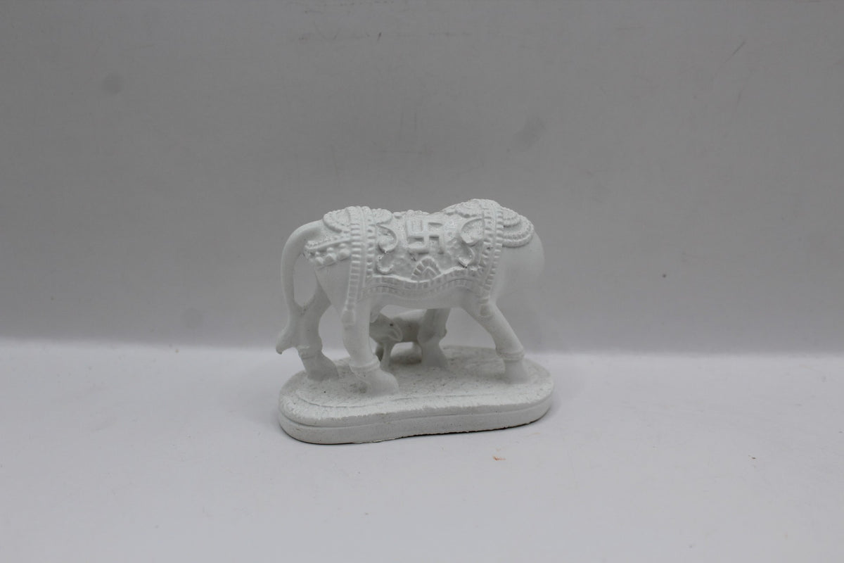 Small white resin cow and calf statue, back view