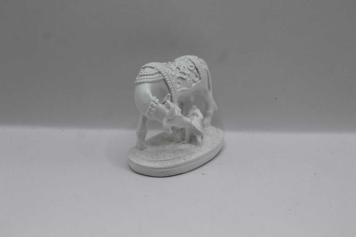 Small white resin cow and calf statue, left side view